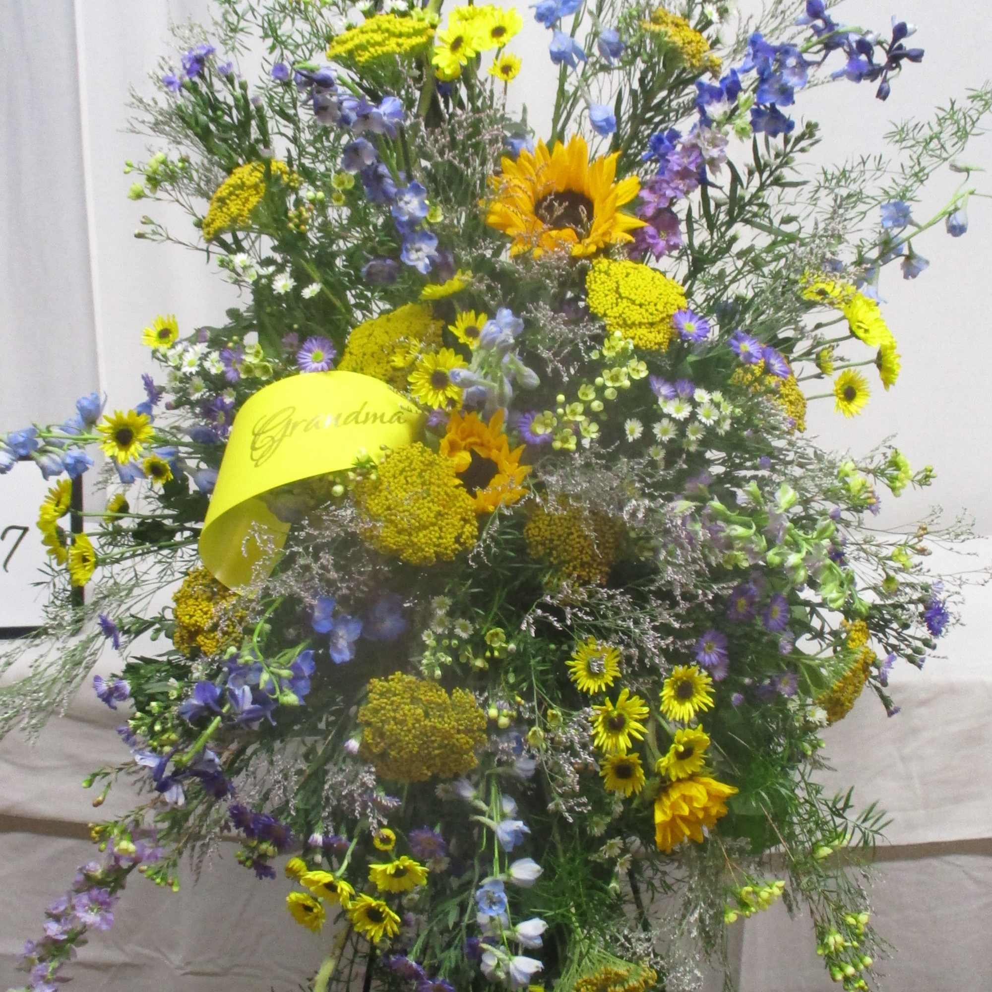 Tall mixed floral spray with yellow sunflowers and blue flowers