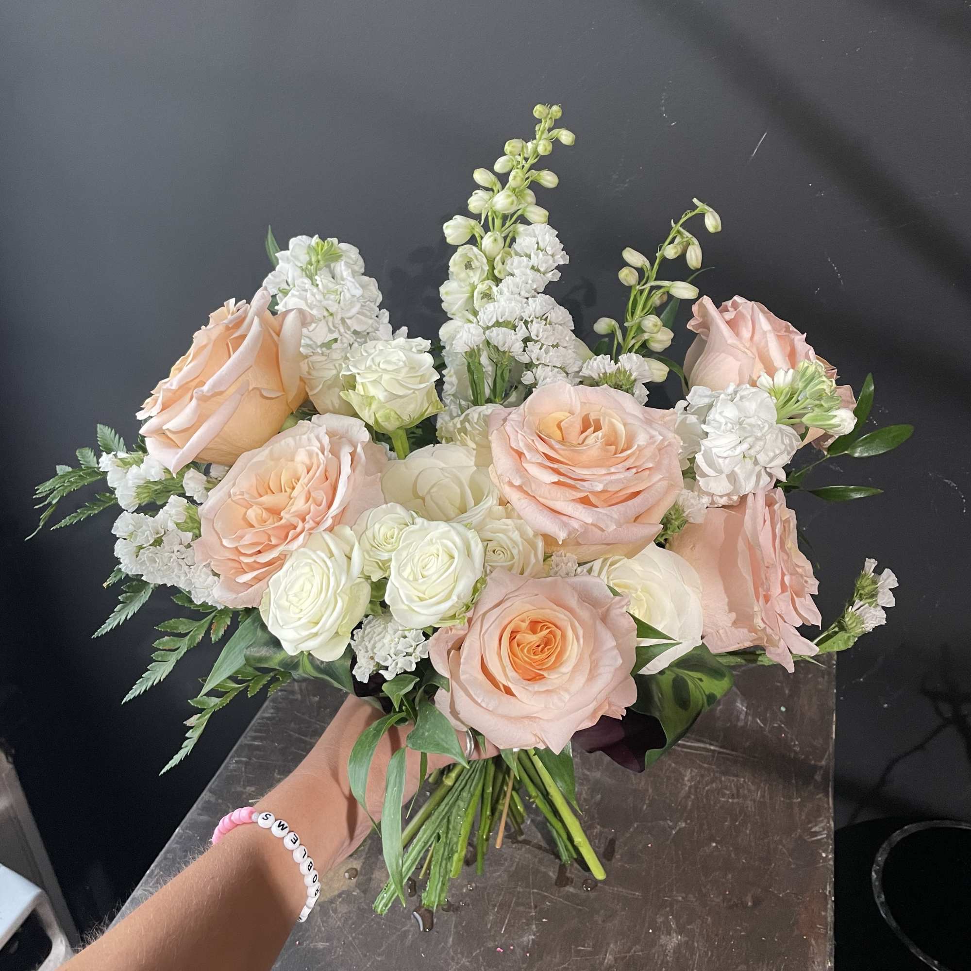 Peach and white rose bouquet with white filler flowers