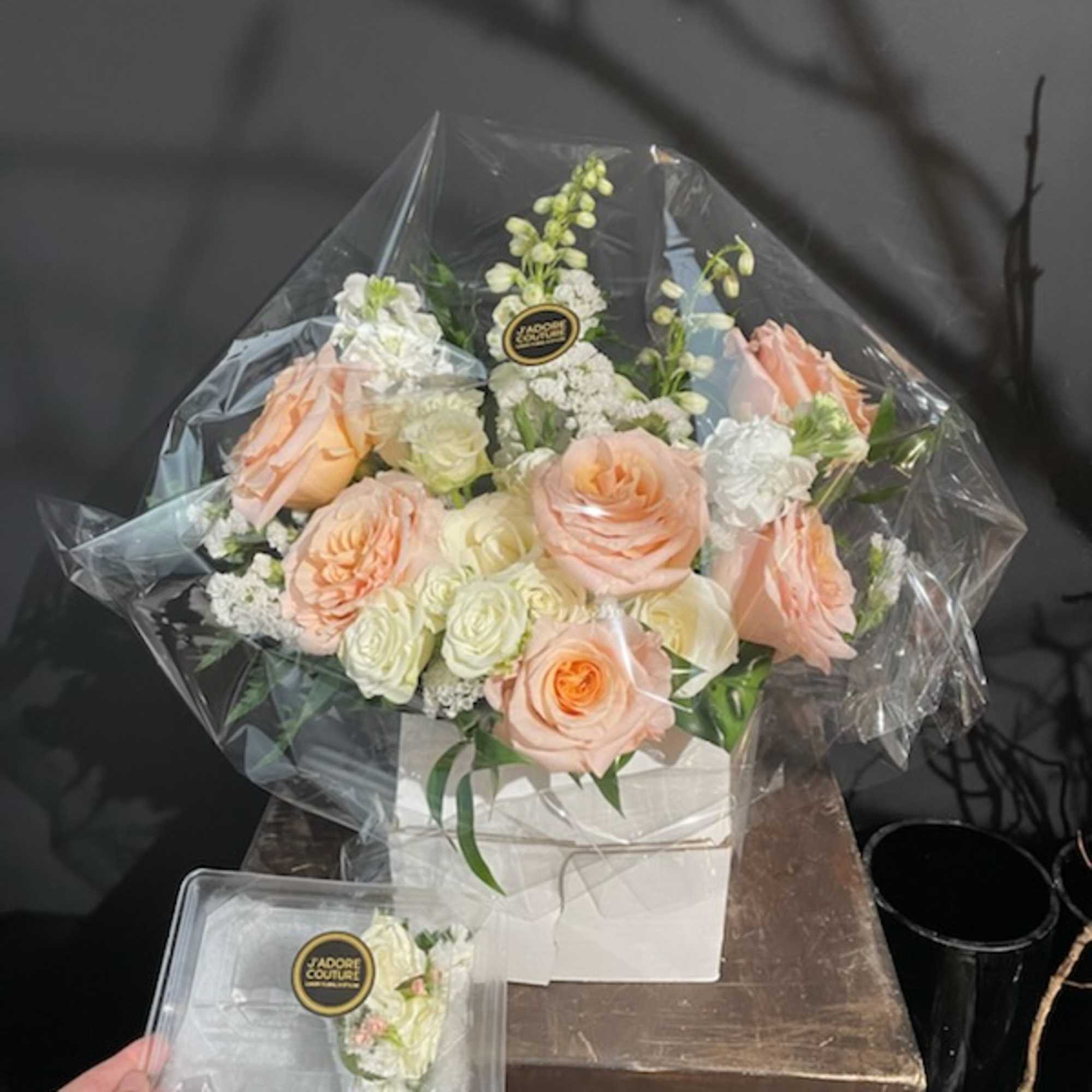 Peach and white rose bouquet in a white box with clear wrap