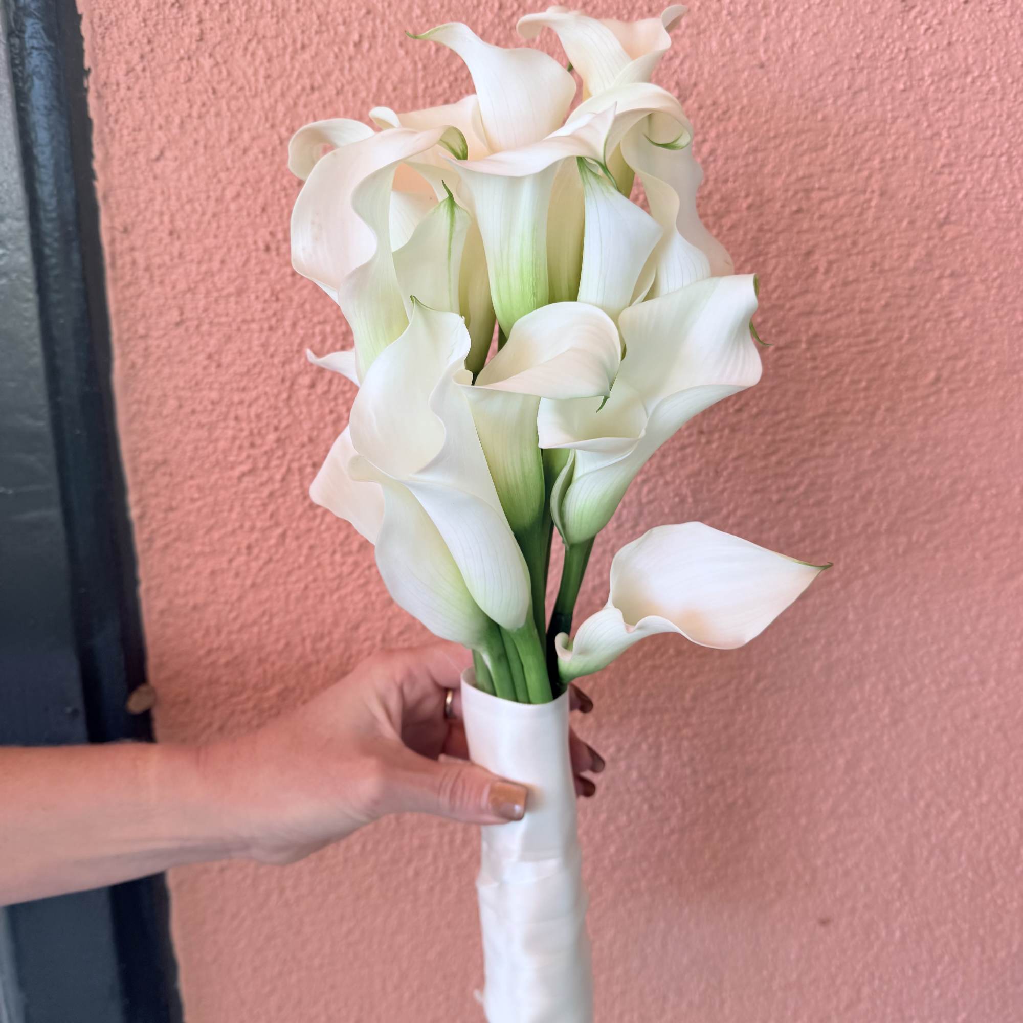 In season white dendrobium orchid, white, spray rose filled with ti-leaf and