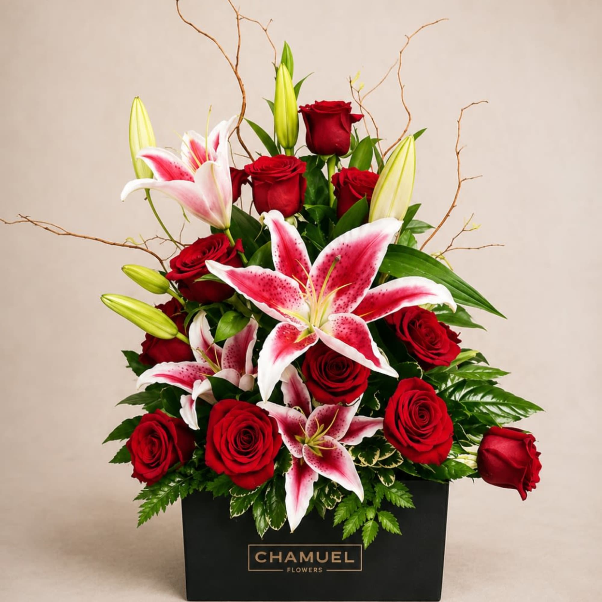 Velvety red roses meet pink-and-white stargazer lilies in a compact, modern gift-box