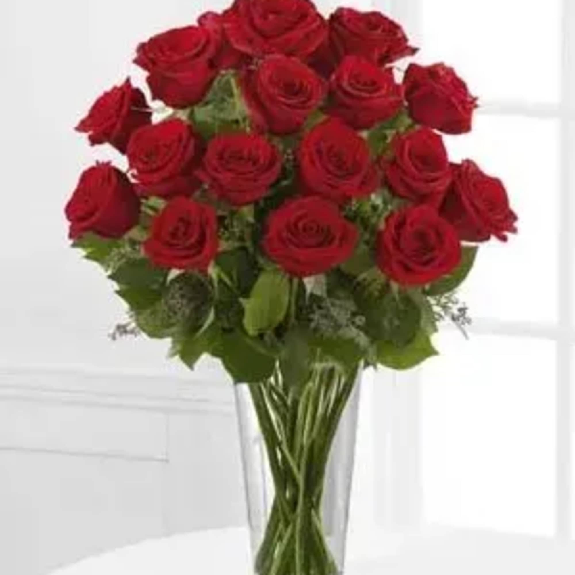 Bouquet of red roses in a clear glass vase