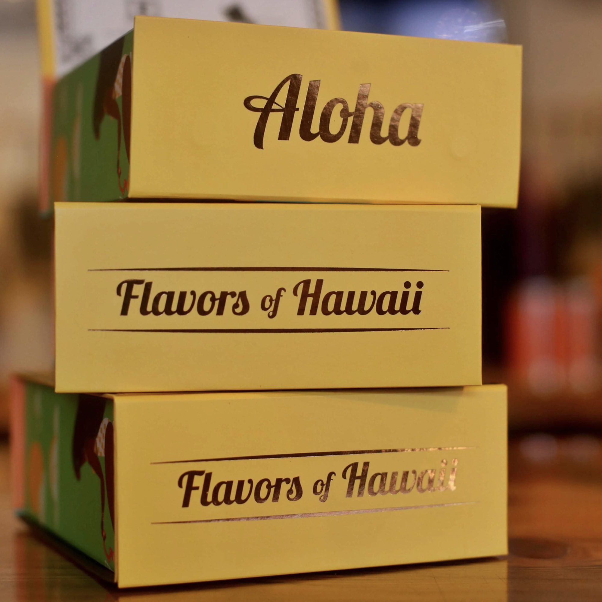 Stacked yellow gift boxes labeled Aloha and Flavors of Hawaii