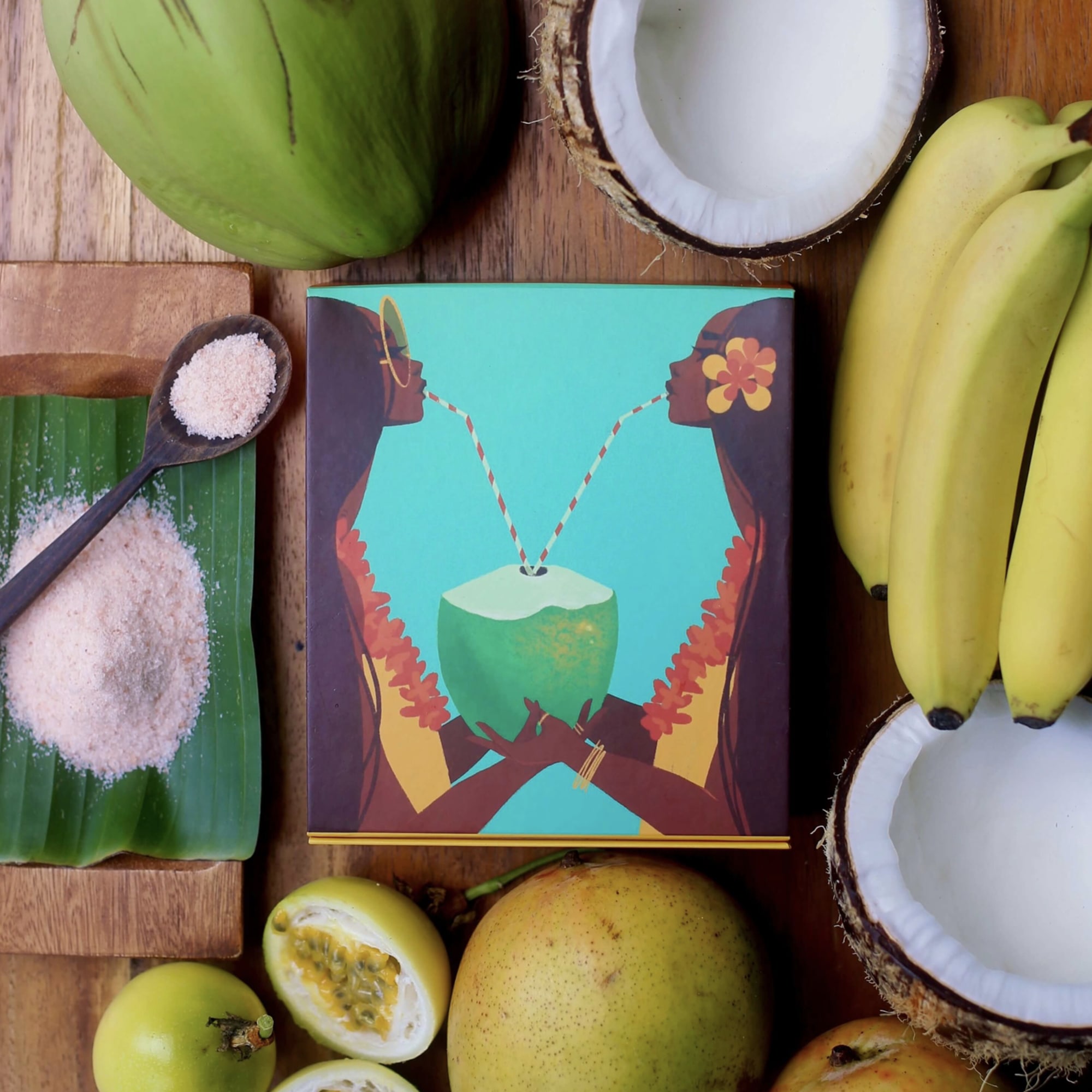 Tropical fruit gift set with coconuts, bananas, mangoes, and salt on a box