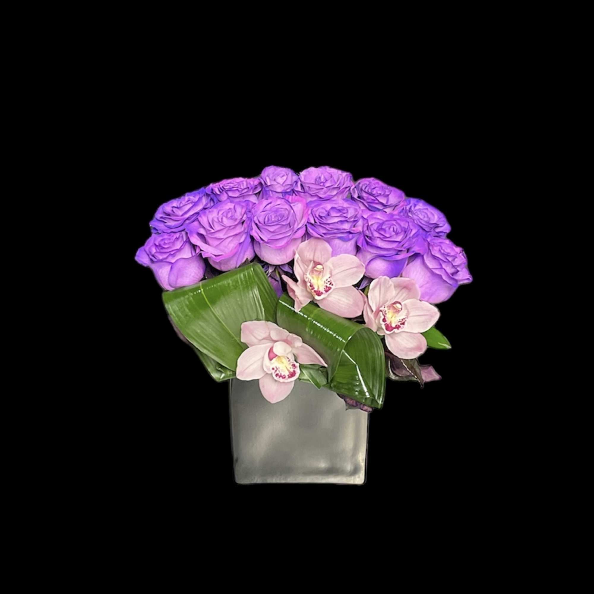 Modern cube vase with purple roses and pale pink orchids on a black background