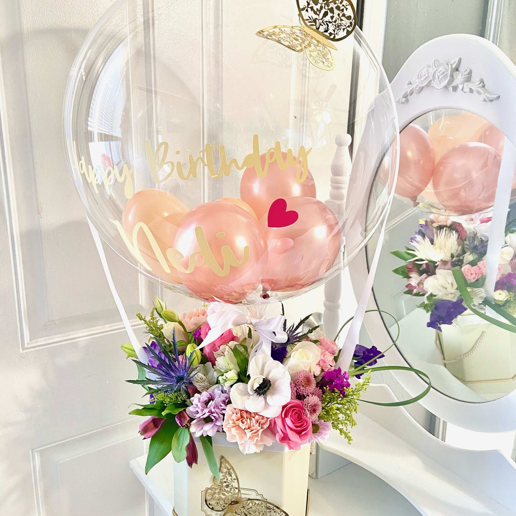 Birthday balloon arrangement with flowers in a decorative box