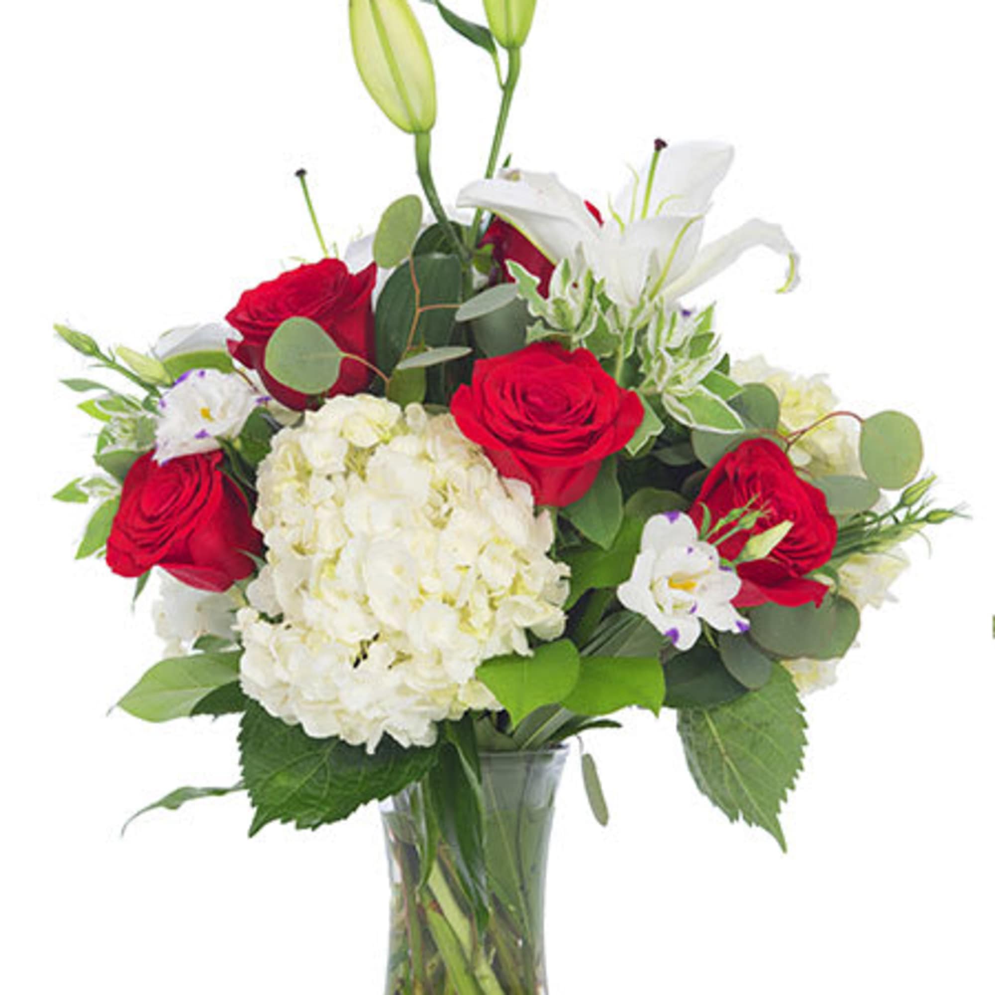 Bouquet of red roses, white lilies, and hydrangea in a glass vase