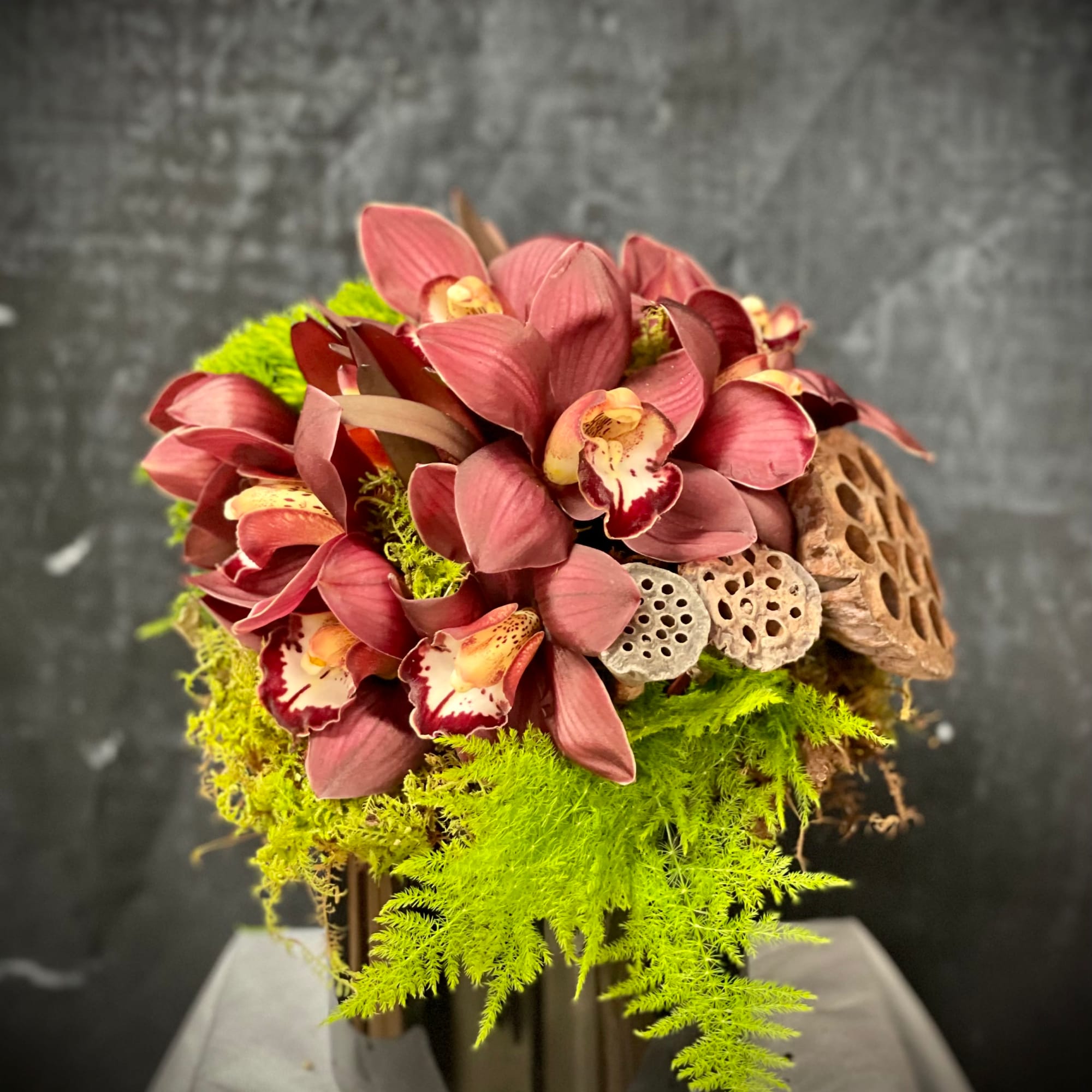 Cymbidium, green dianthus, lotus and greenery.