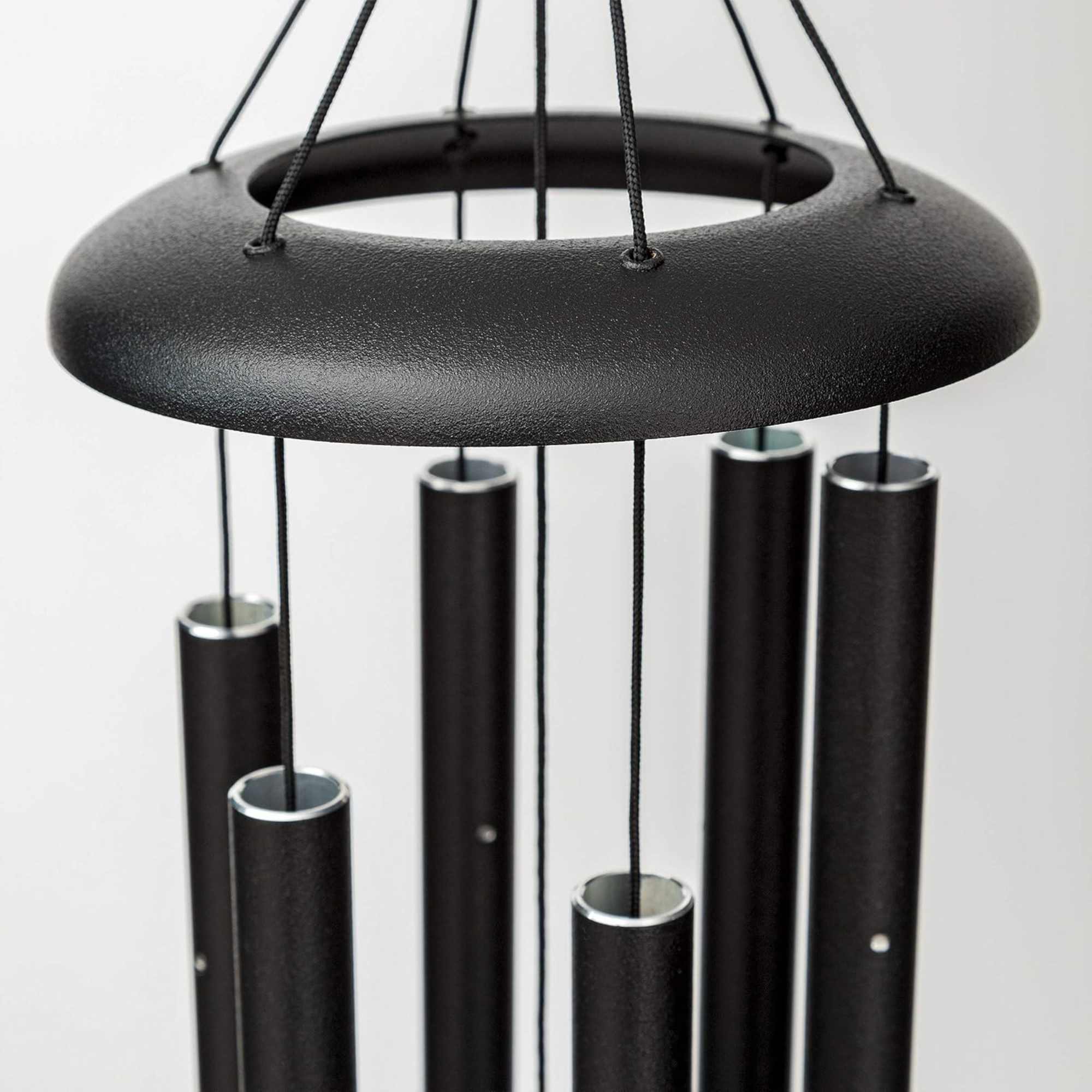 Black metal wind chime with hanging tubes