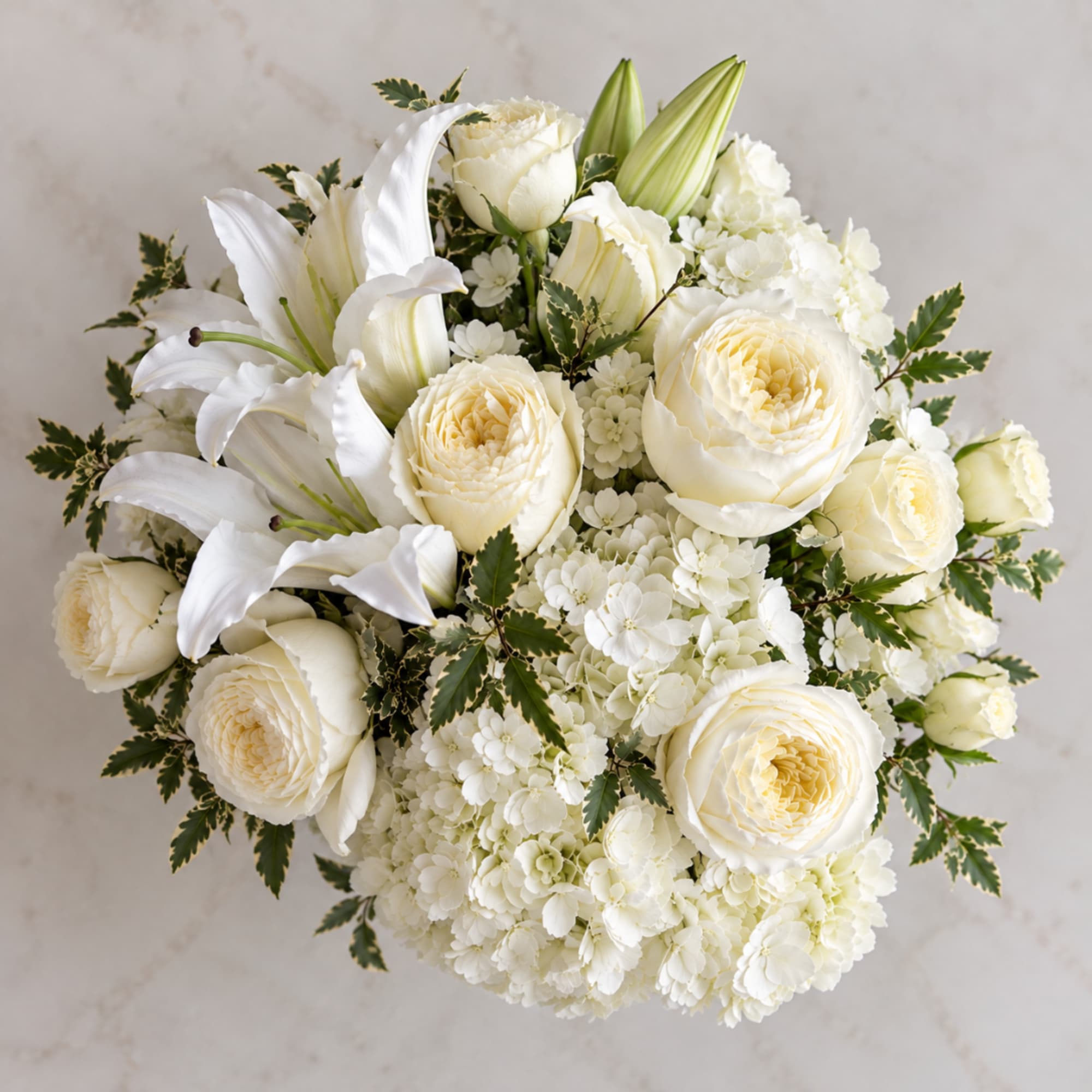 White floral bouquet with lilies, roses, and hydrangeas