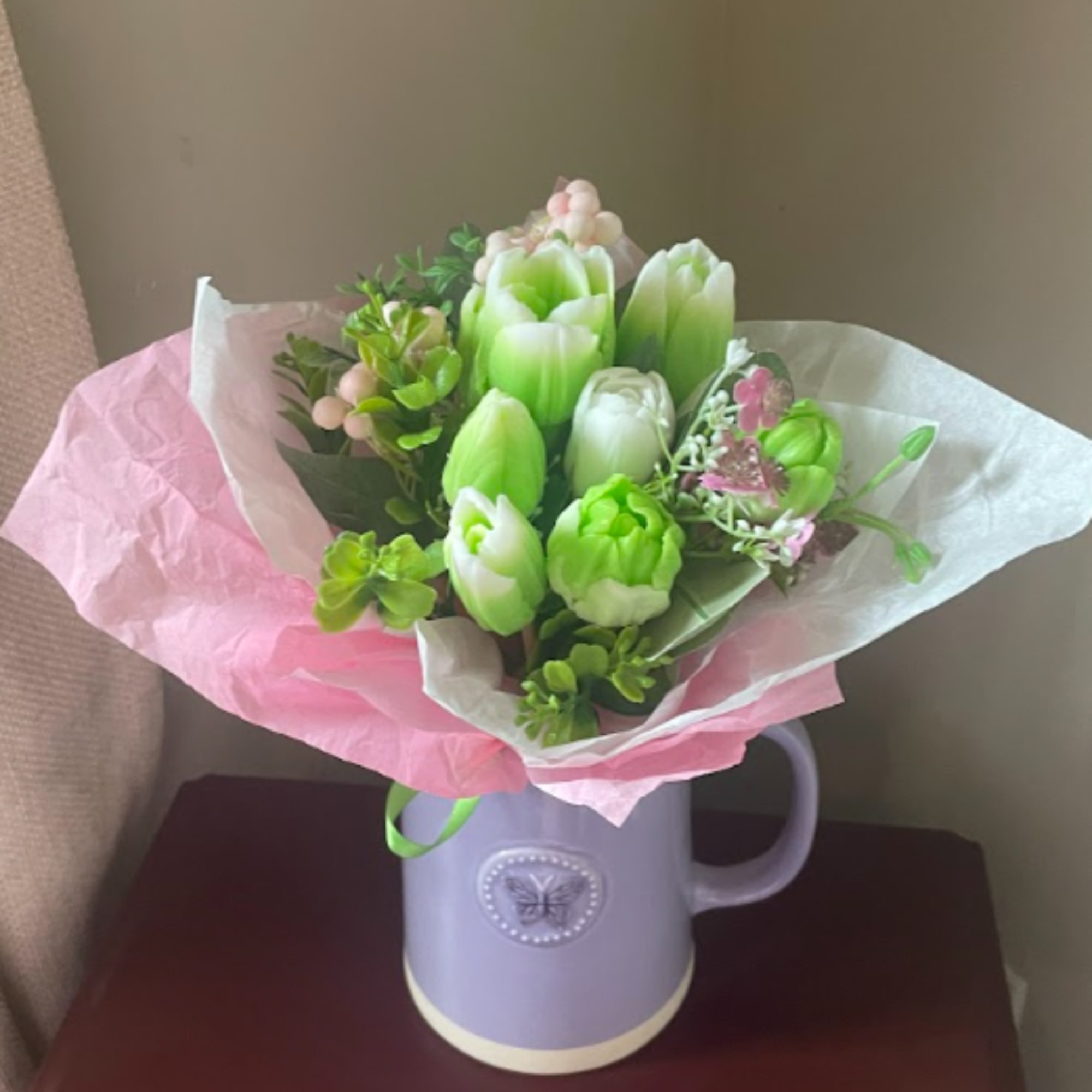 Bouquet of green and white tulips in a lavender mug vase