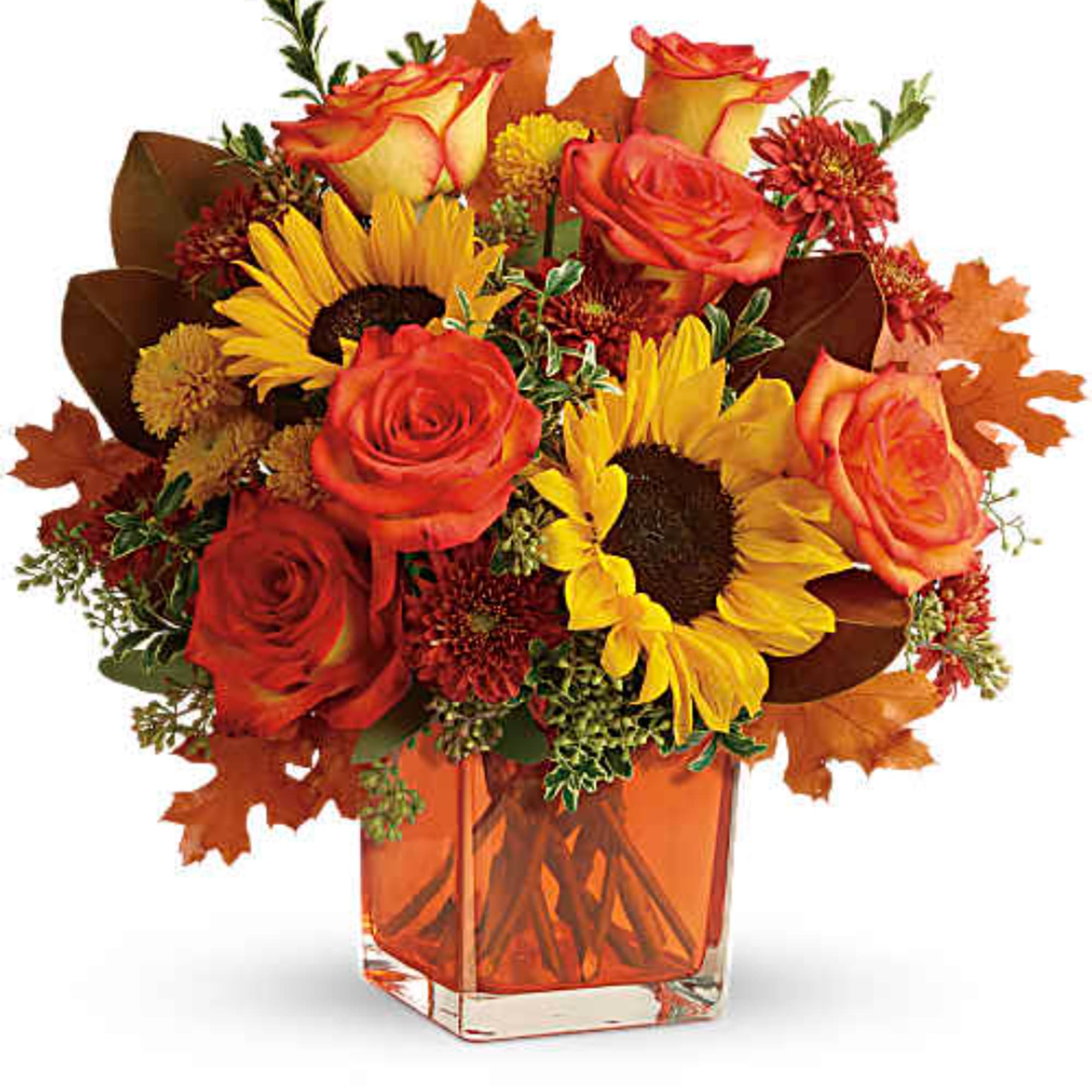 Bouquet of red roses and yellow sunflowers in an orange glass vase