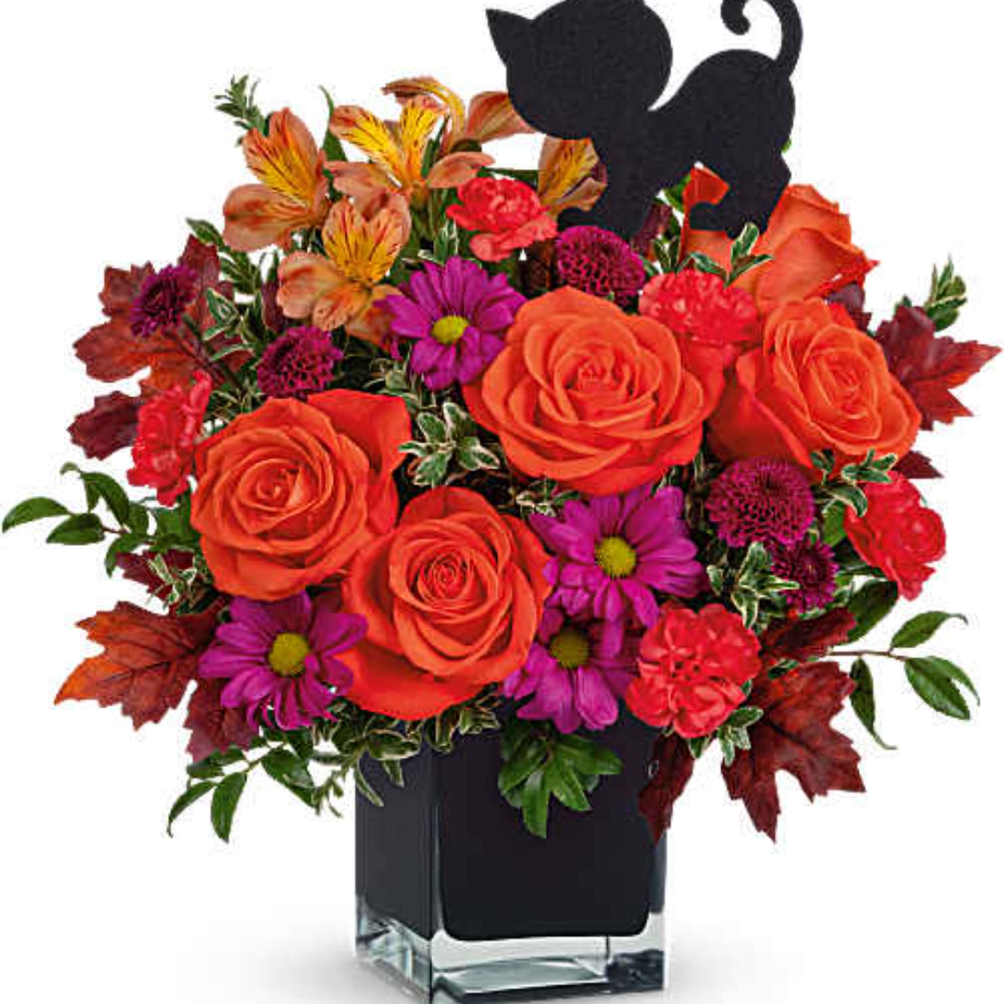 Orange roses and purple daisies in a black vase with autumn leaves