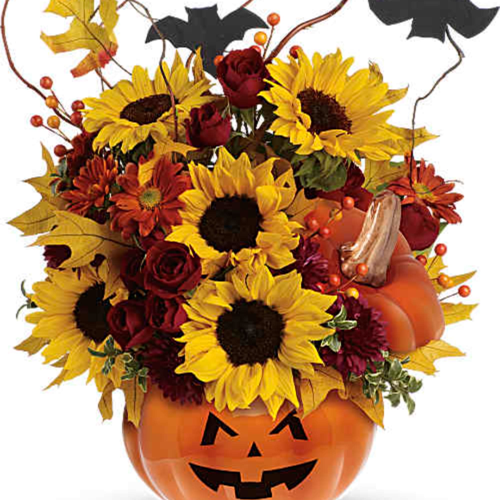 Fall bouquet with sunflowers and roses in a jack-o'-lantern pumpkin container