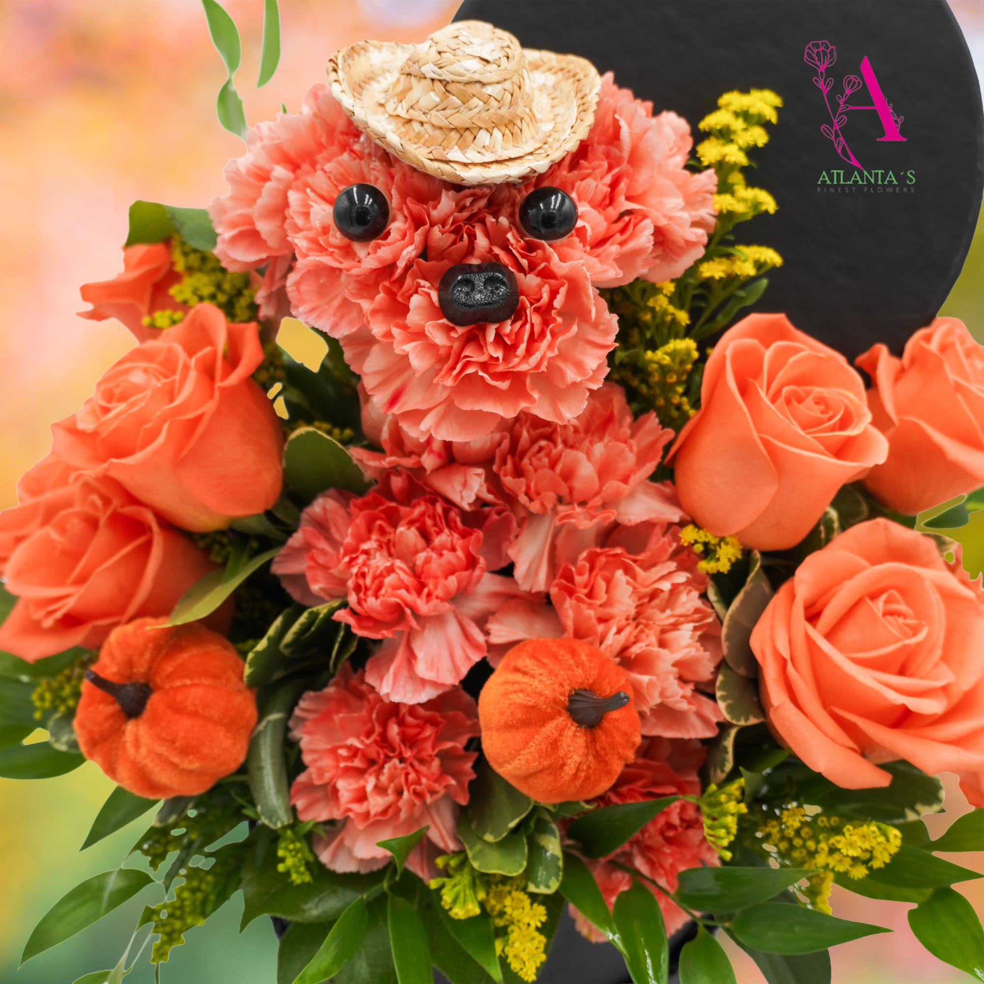 Coral carnation and rose bouquet arranged as a teddy bear with a straw hat