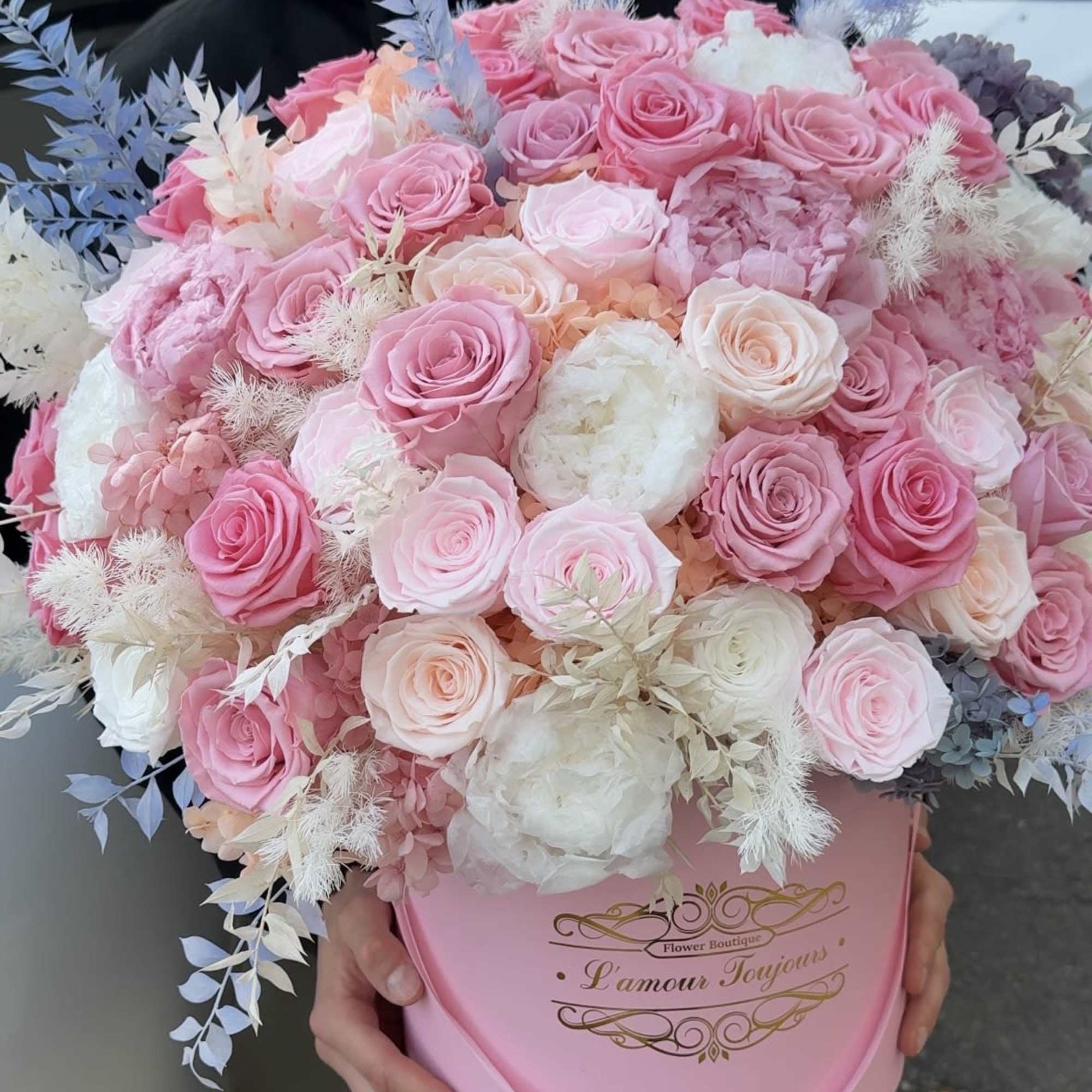 Large pink and white rose bouquet in a pink hat box