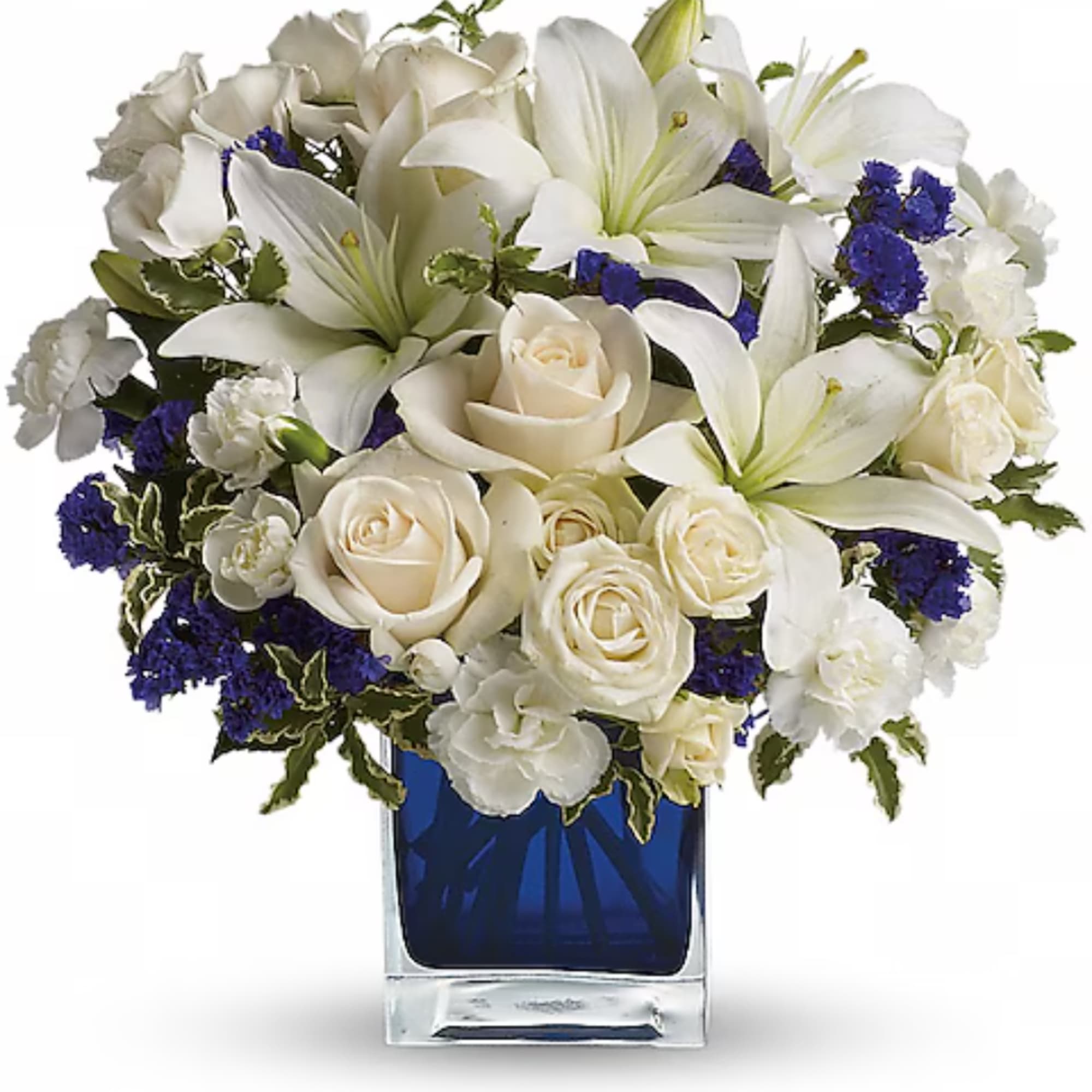 White lilies and roses in a blue glass vase with purple accents