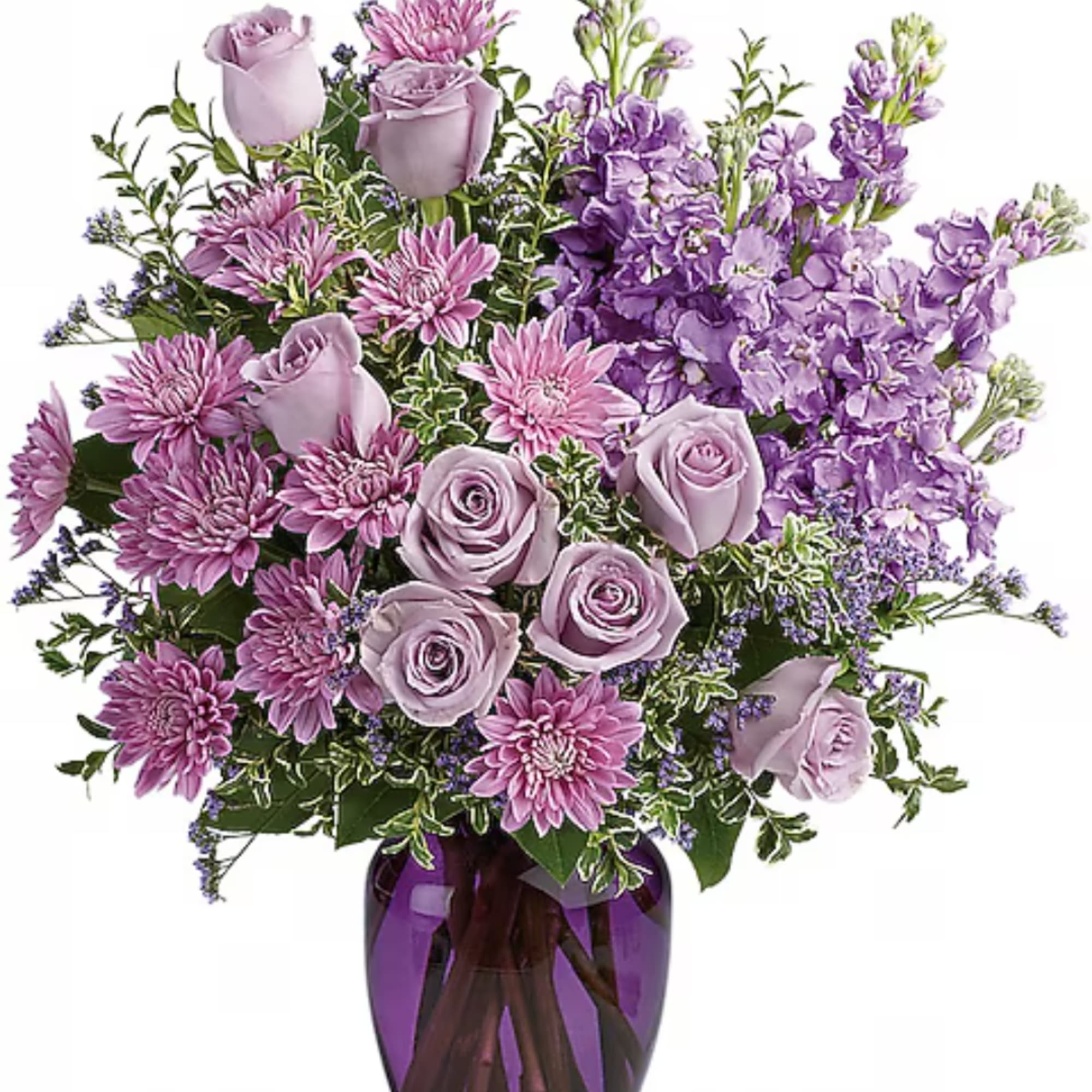 Lavender roses and purple flowers arranged in a glass vase