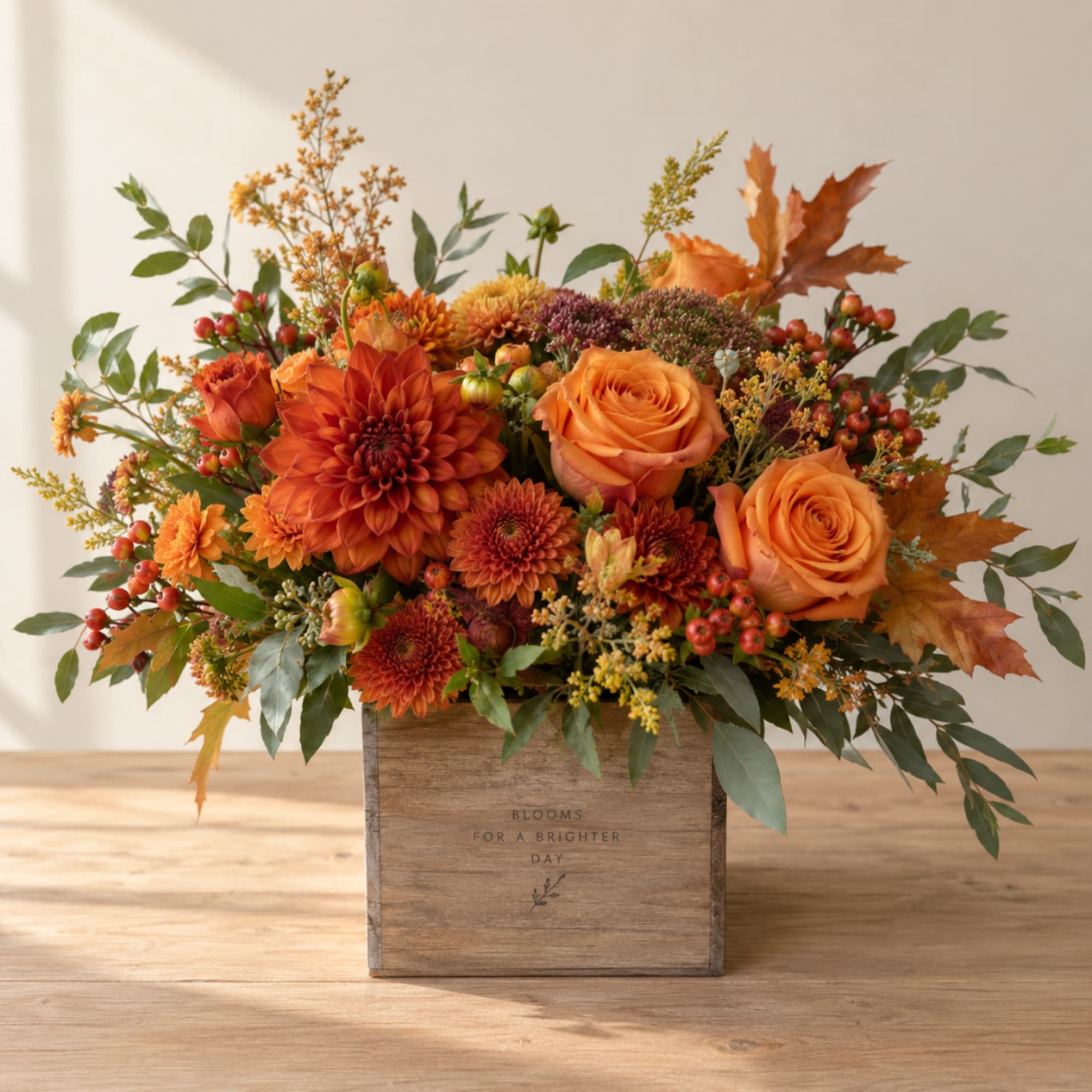 Orange roses and chrysanthemums in a wooden box with autumn leaves, photo 2 of 2