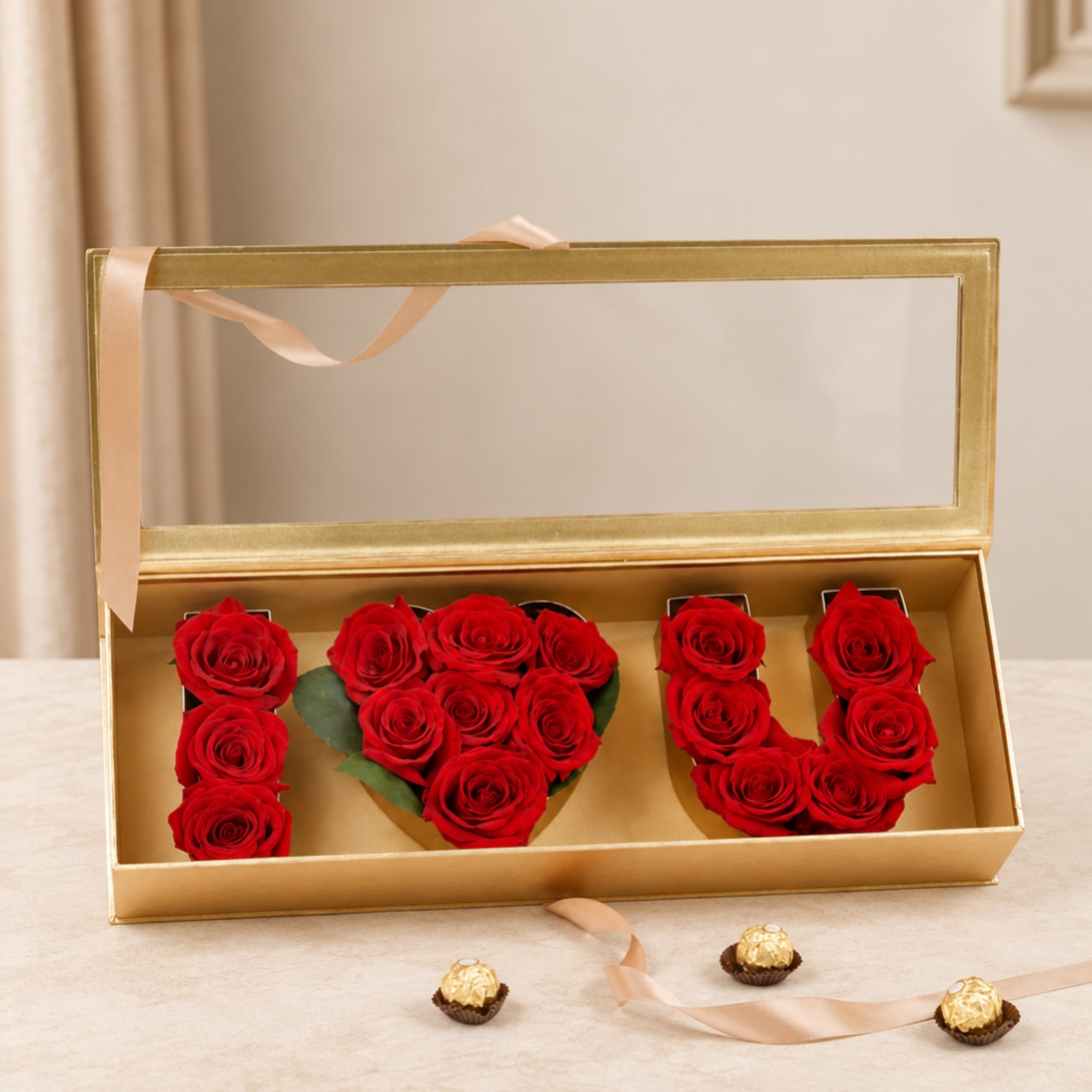 Gold gift box with red roses arranged as letters and three chocolates below