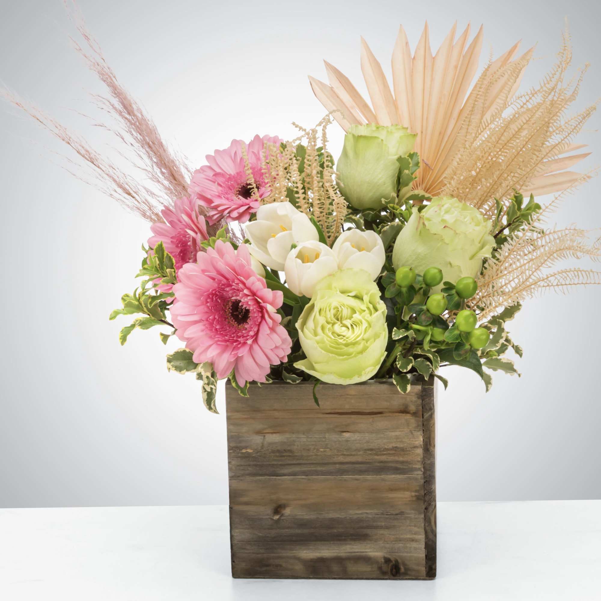 A boho arrangement featuring an eclectic mix of flowers and textures that