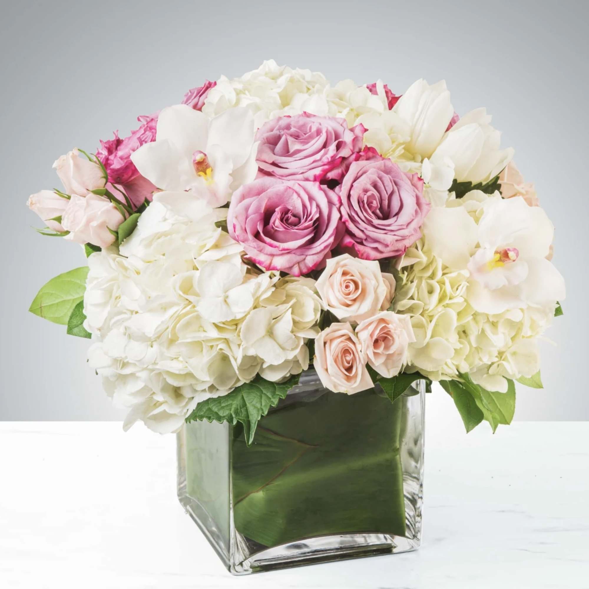 Classic and Beautiful, this large arrangement whispers luxury. Soft pinks, whites and