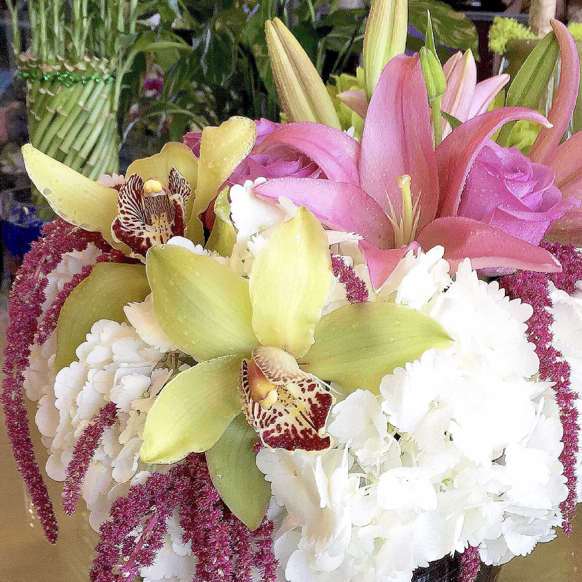 Bouquet of pink lilies, white chrysanthemums, and green orchids