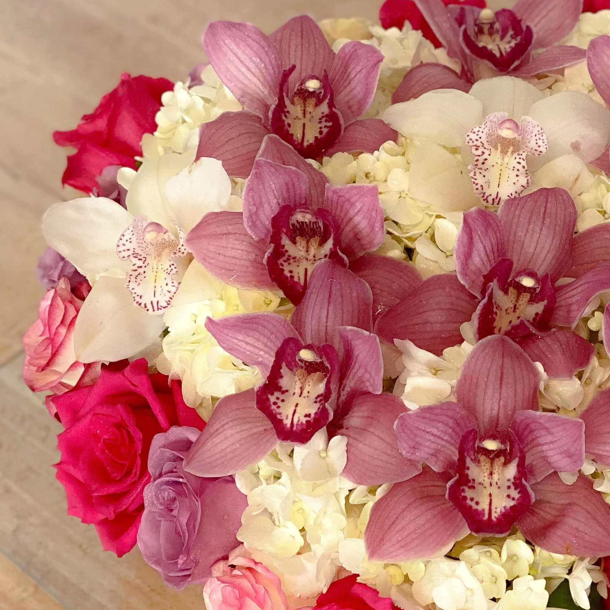 Bouquet of pink orchids, white hydrangeas, and pink roses