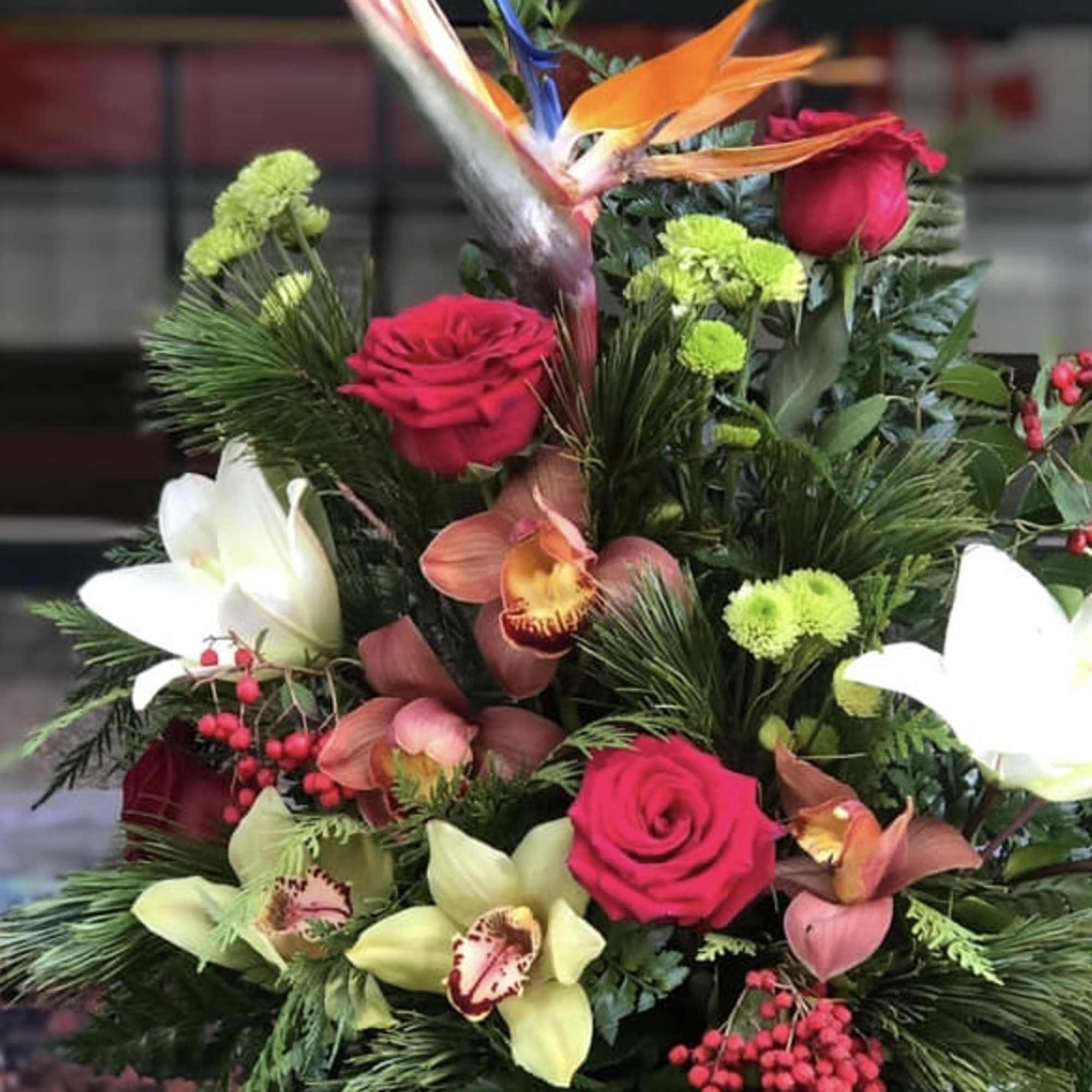 Tropical bouquet with red roses, white lilies, and bird of paradise