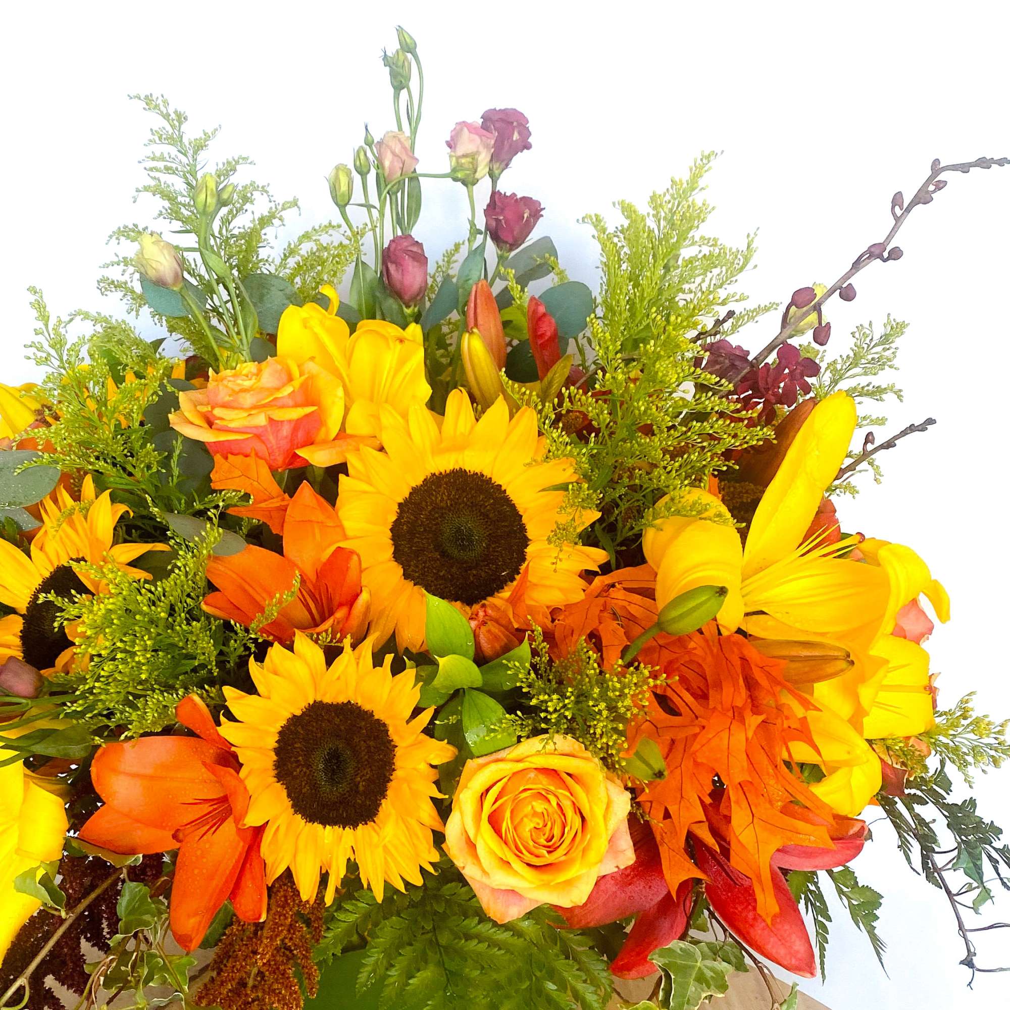 Bouquet of sunflowers, roses, lilies, and orange blooms