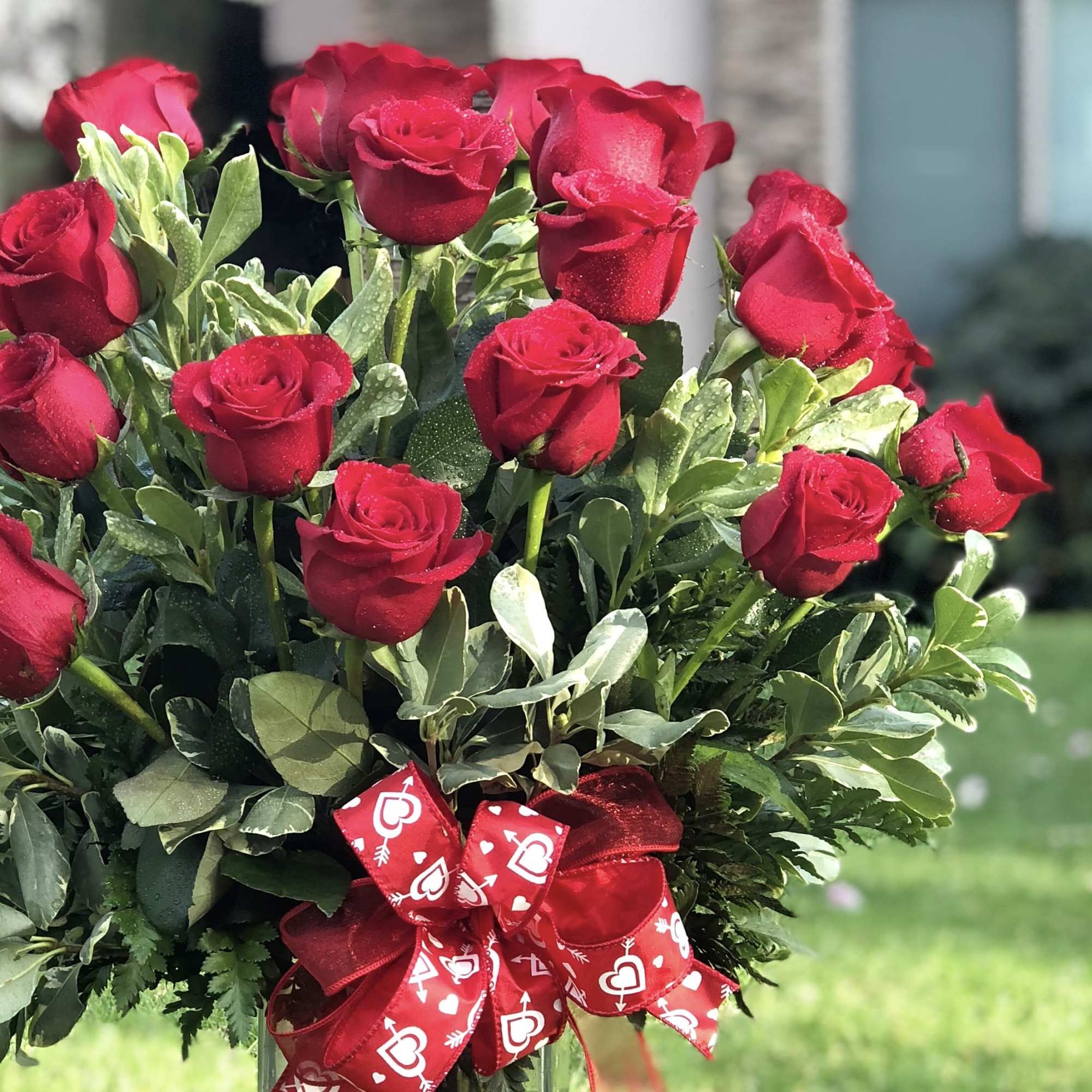 Bouquet of red roses with a red heart-pattern ribbon