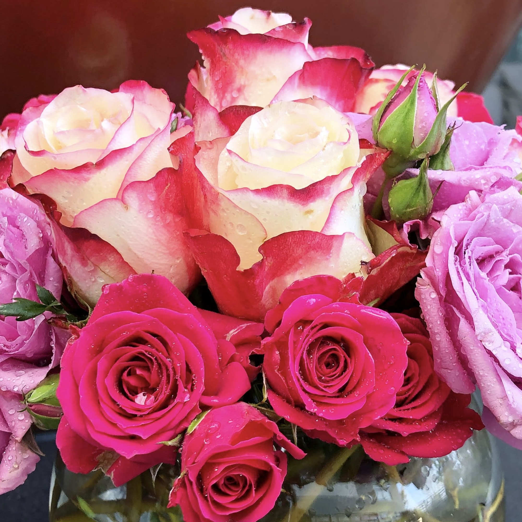 Bouquet of pink and cream roses in a glass vase
