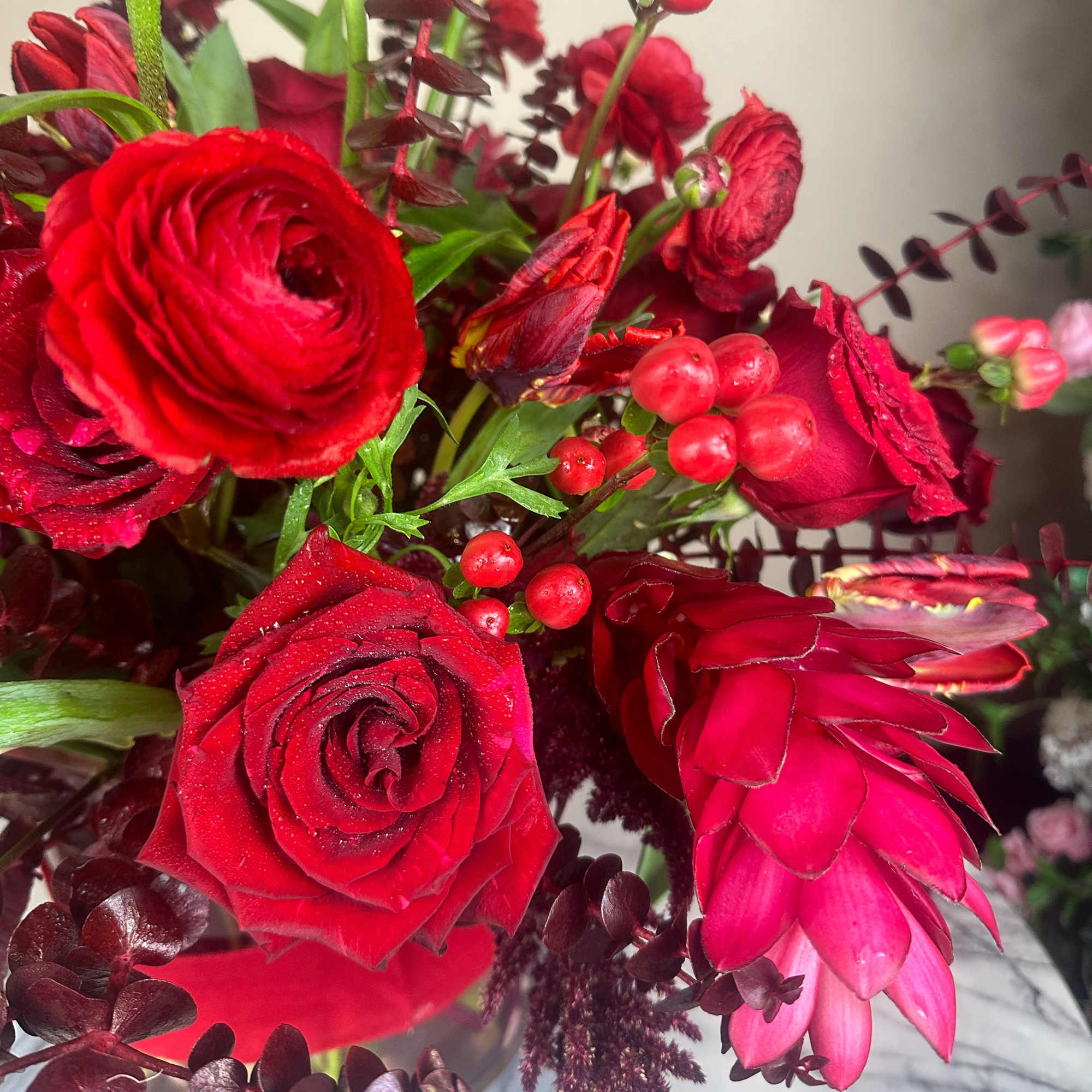 Red roses and pink protea in a bouquet