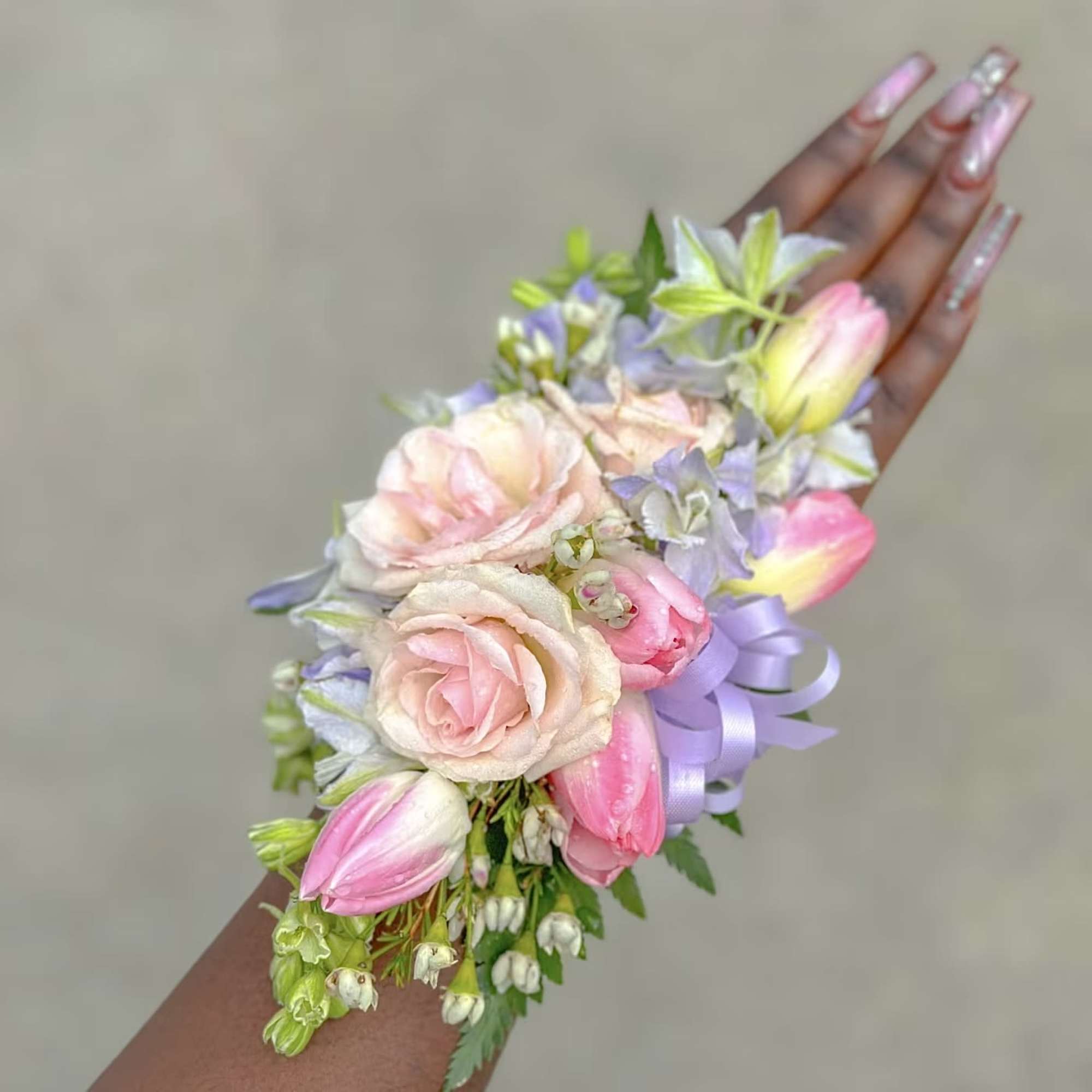 Handheld pastel flower corsage with pink roses and tulips
