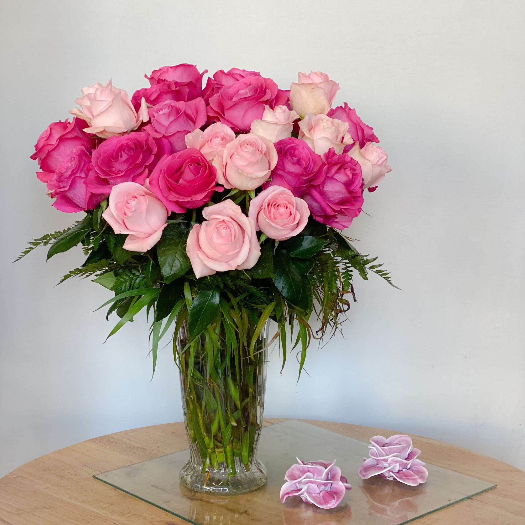 Pink and blush roses arranged in a clear glass vase