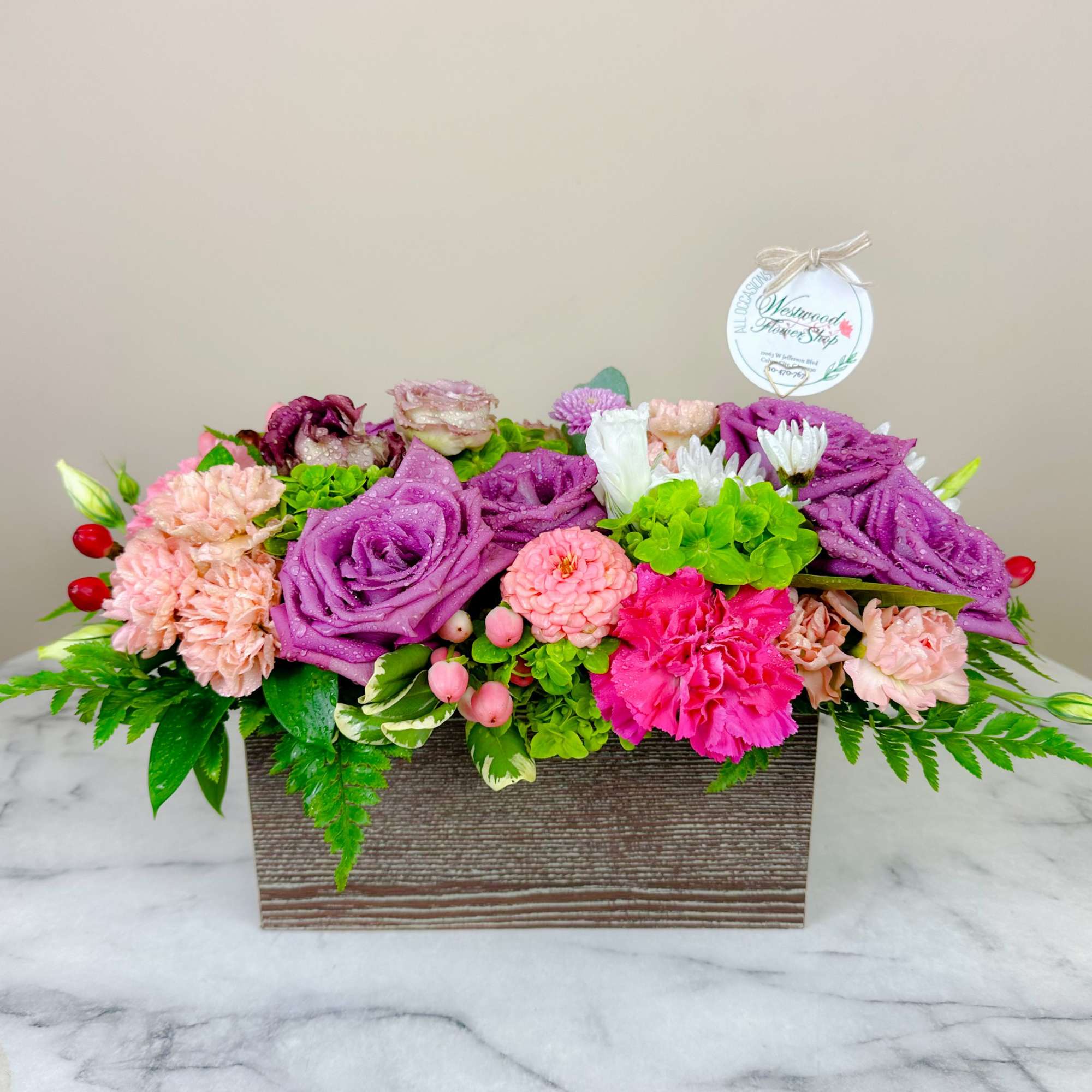 Mixed pink and purple flower arrangement in a rectangular box, photo 3 of 4