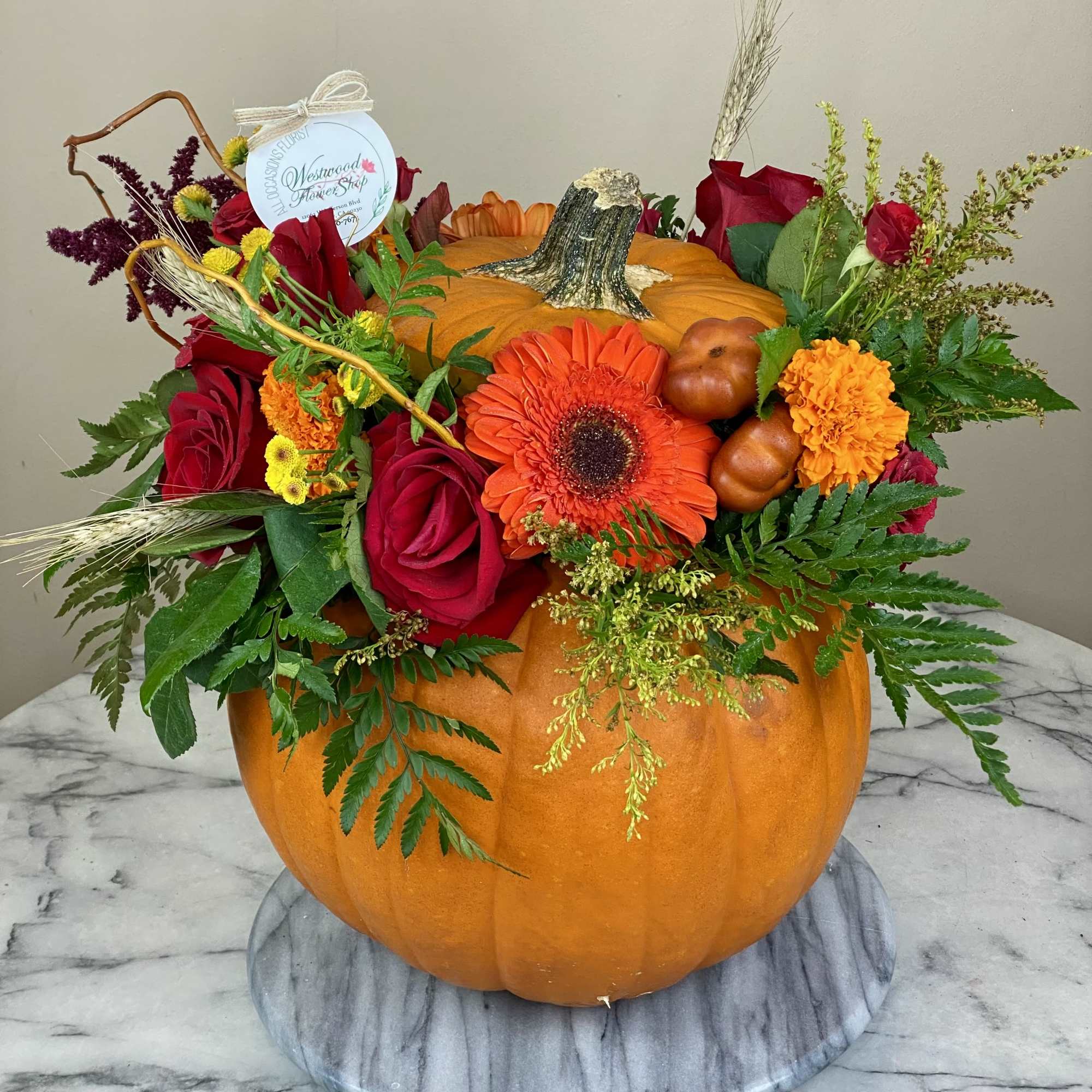 Pumpkin centerpiece with red roses and orange gerbera daisies, photo 5 of 5