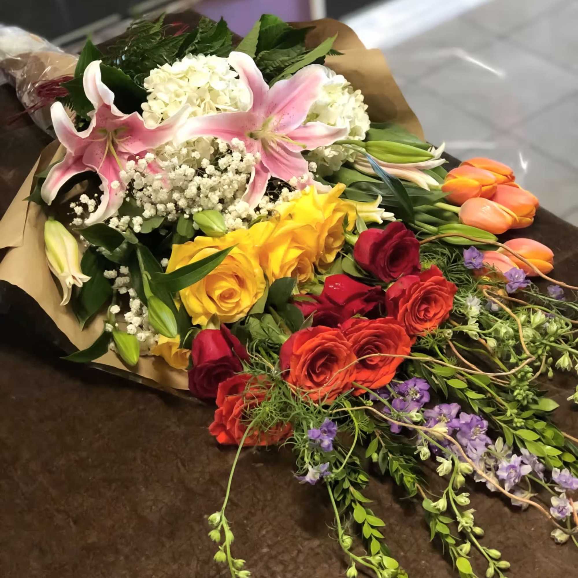 Mixed bouquet with pink lilies, roses, and white hydrangeas