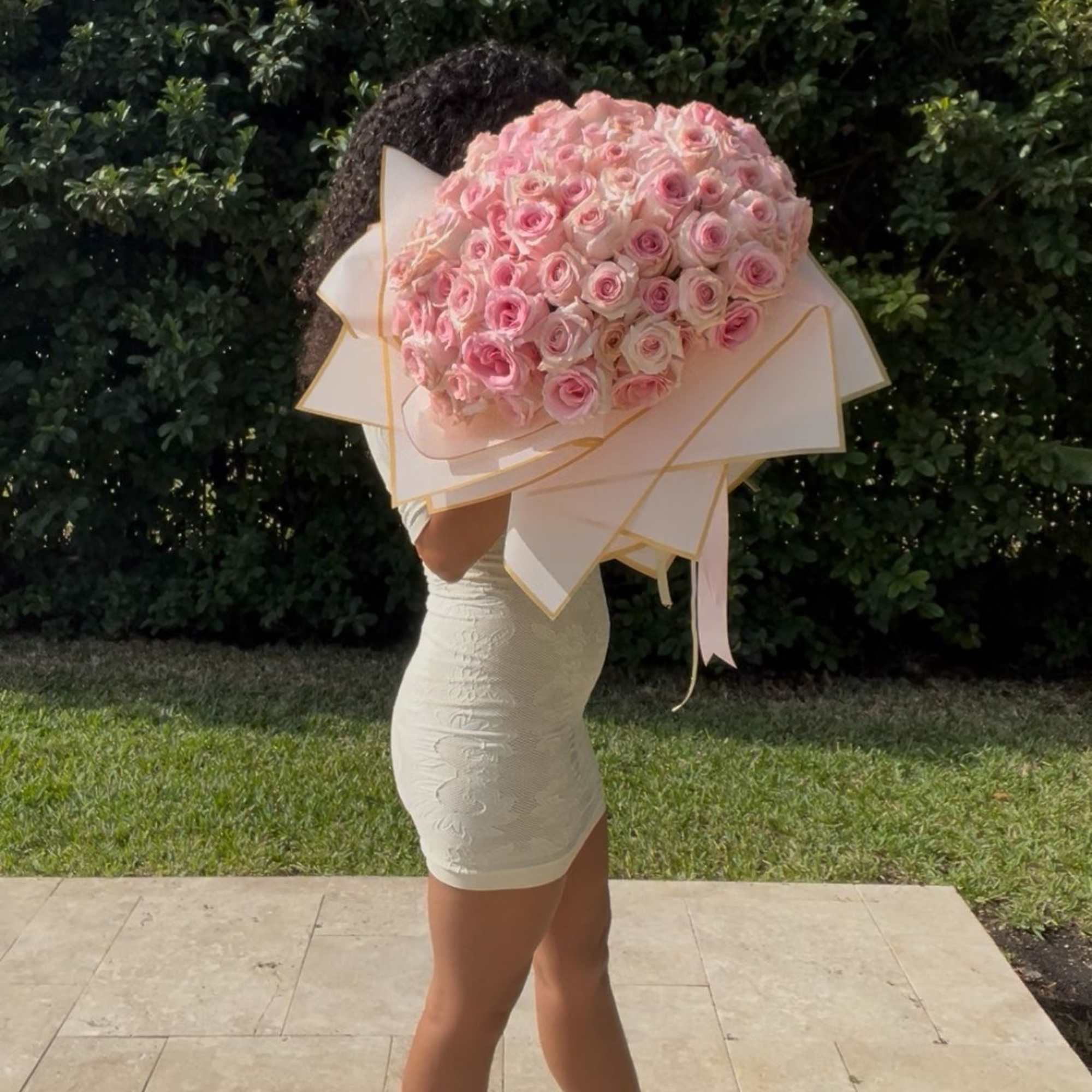 Large bouquet of pink roses wrapped in cream paper