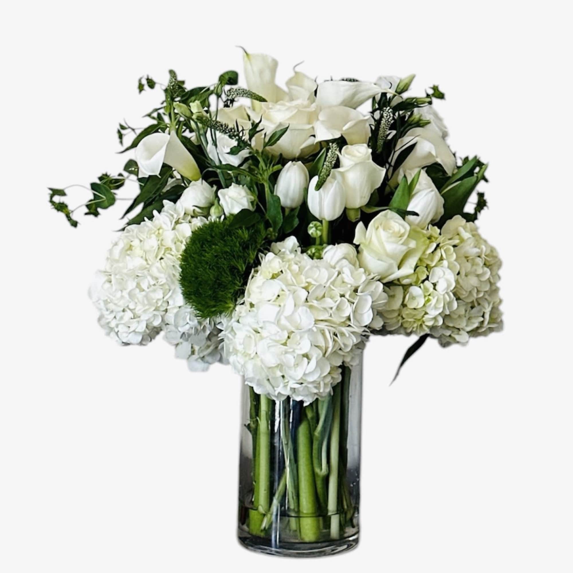 Handcrafted in a clear glass cylinder vase, the design pairs a structured