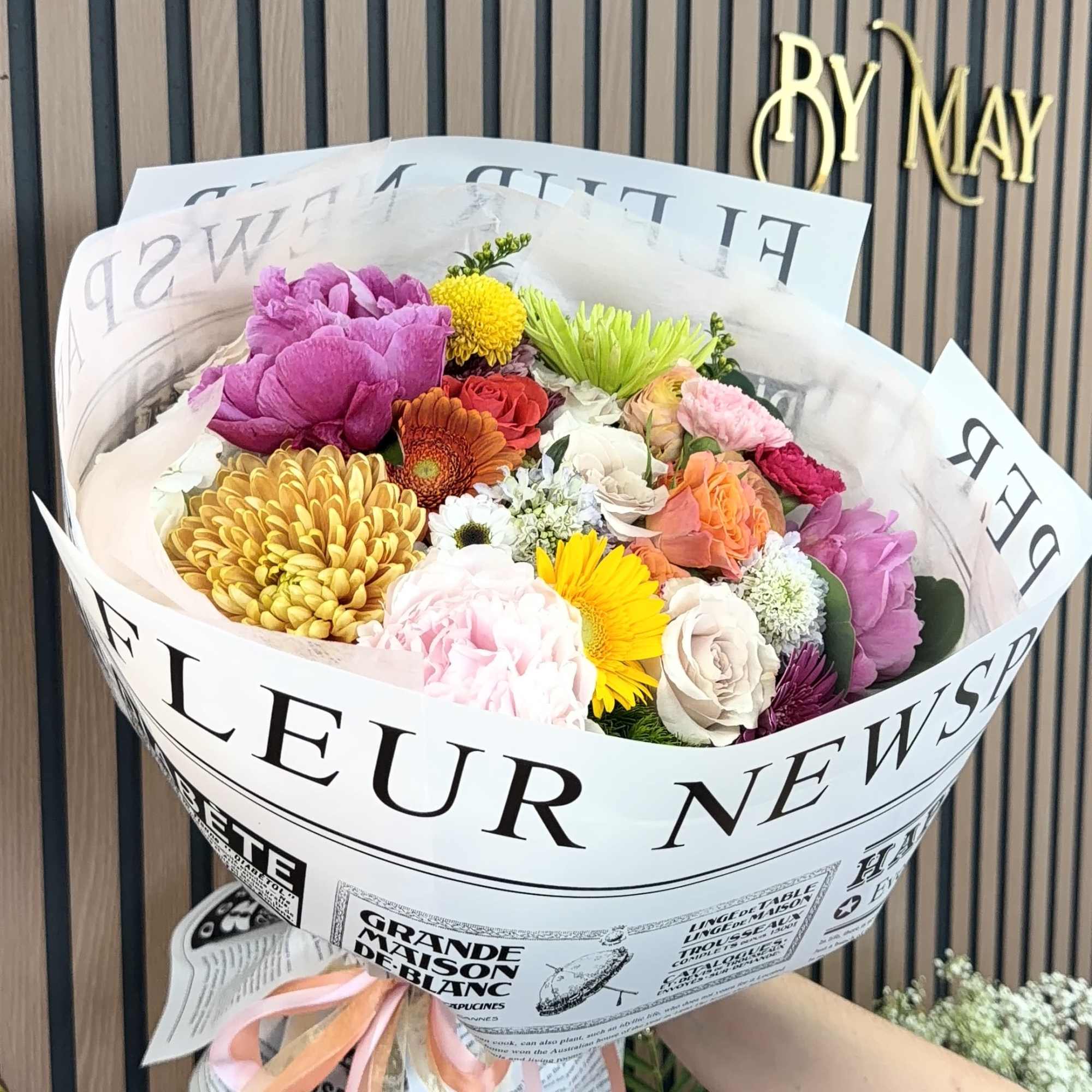 A rounded, hand-tied bouquet bursting with cheerful color-perfect as a birthday bouquet