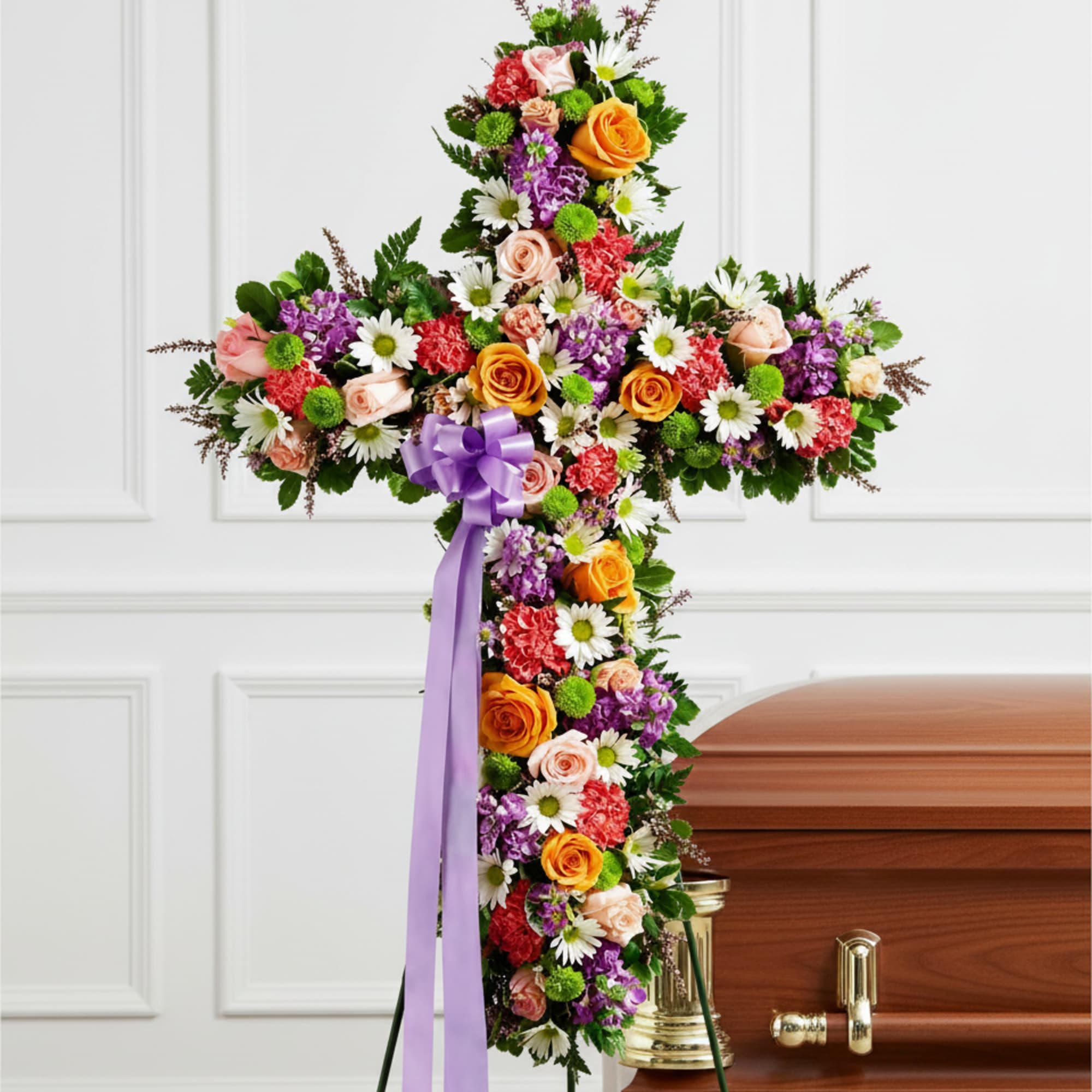 A densely covered standing cross in mixed pastel and bright tones creates