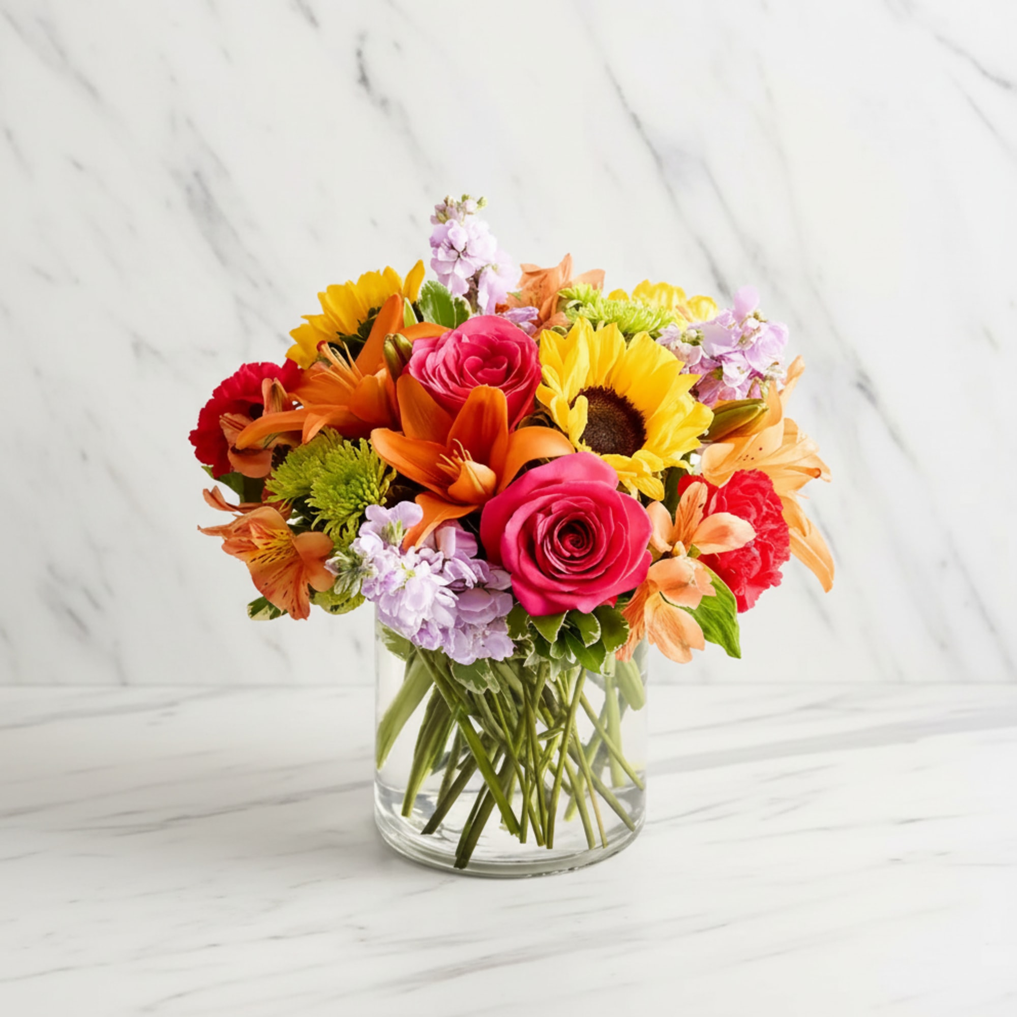 Bright, cheerful color bursts make this mixed flower arrangement a joyful pick