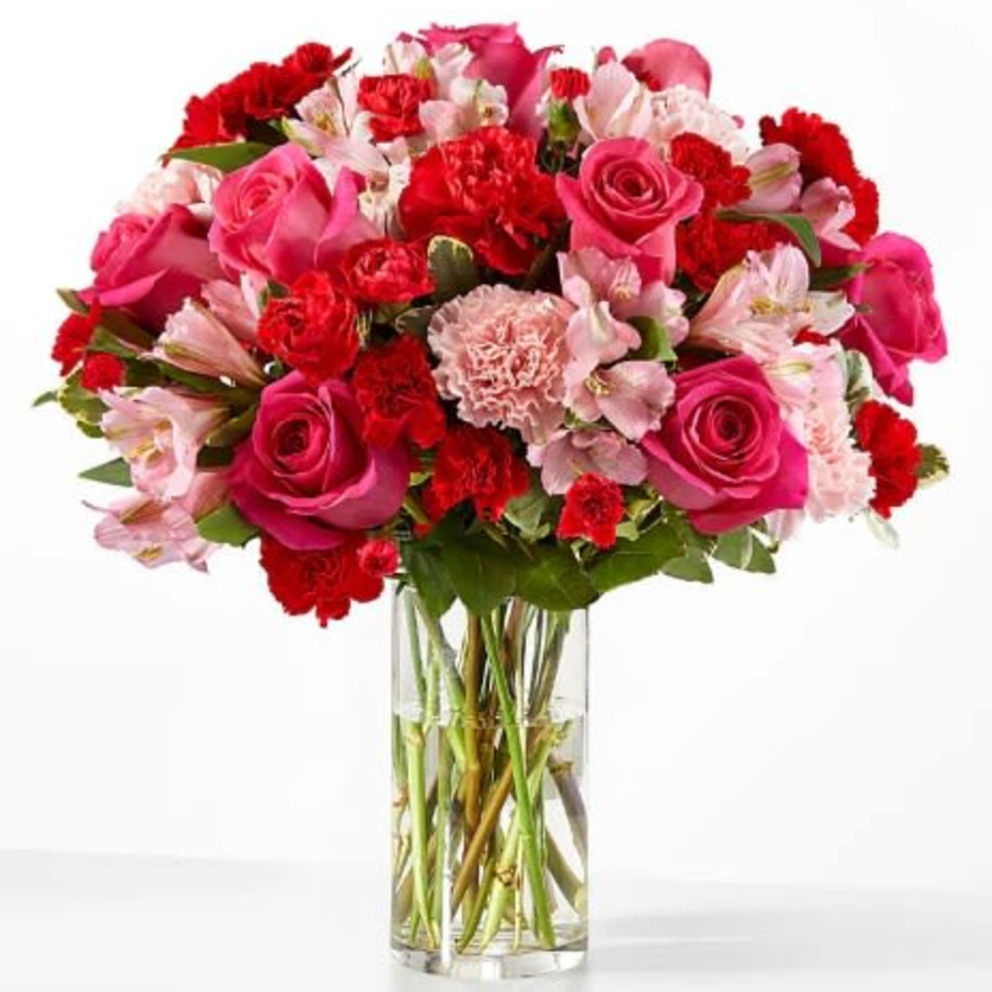 Pink roses with red and light pink flowers in a clear glass cylinder vase
