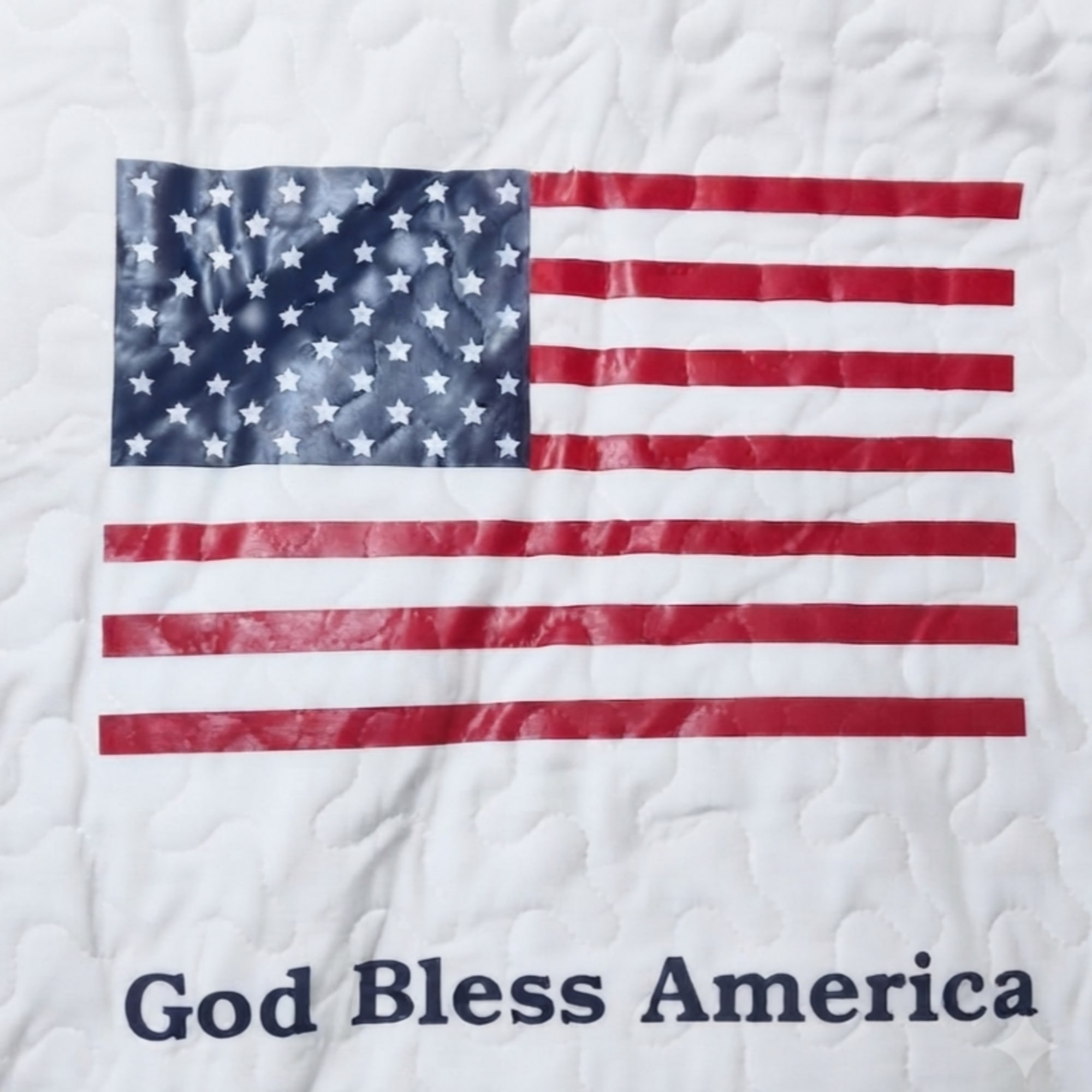 Quilt with an American flag and the words God Bless America