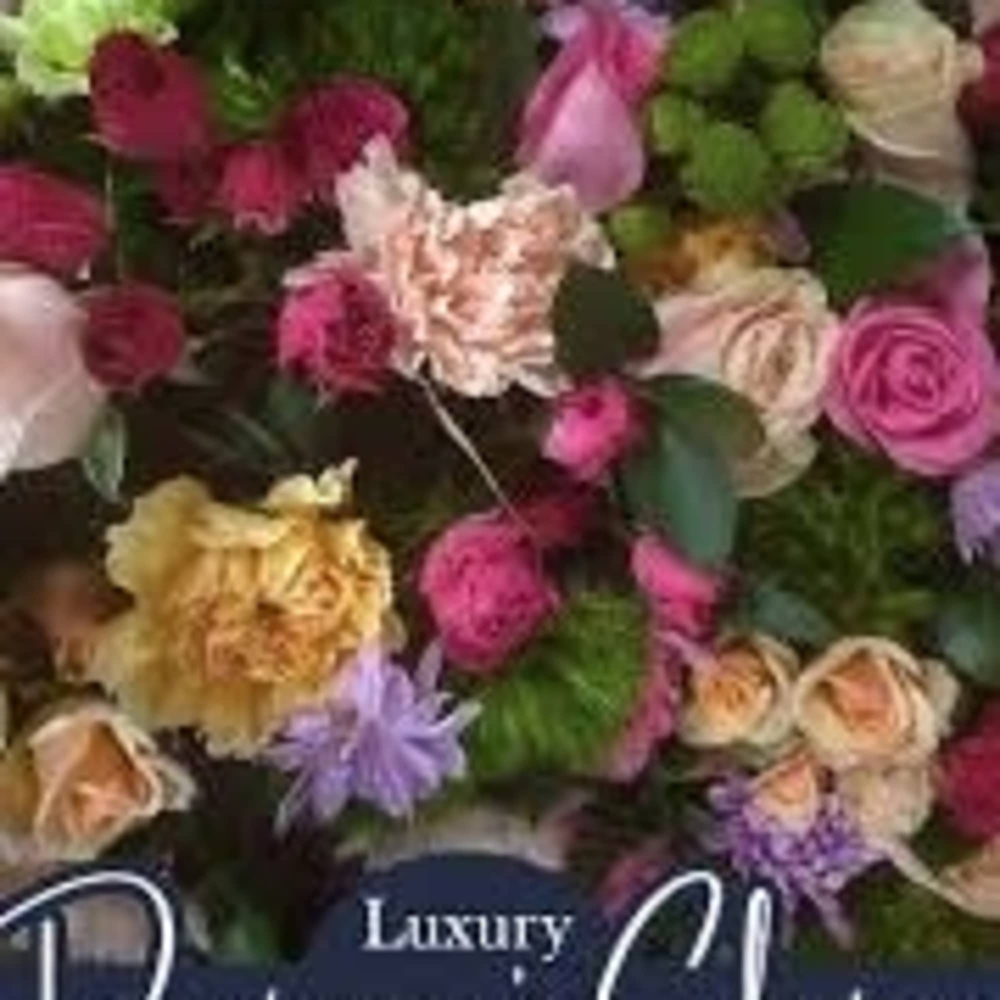 A lush cascade of mixed roses, ruffled carnations, and cheerful high end