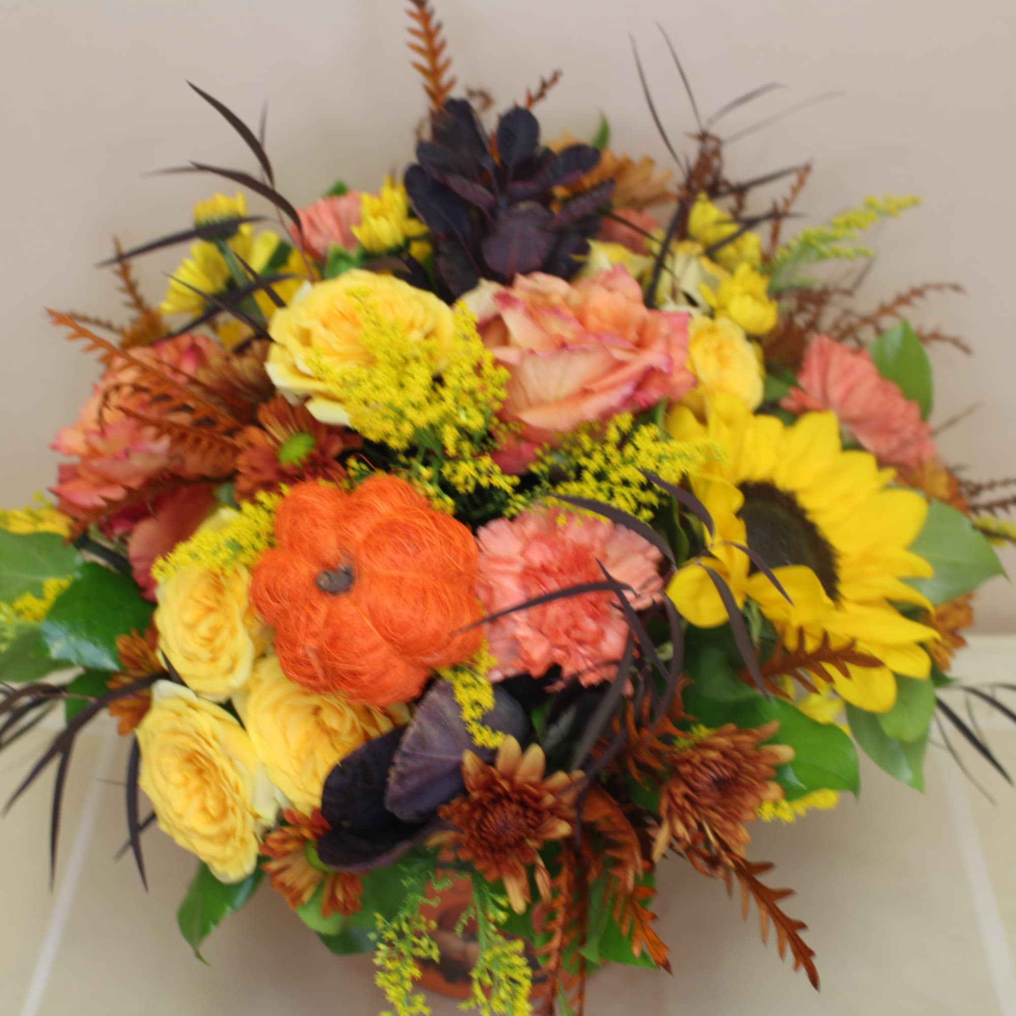 Autumn bouquet with sunflowers, roses, and orange accents