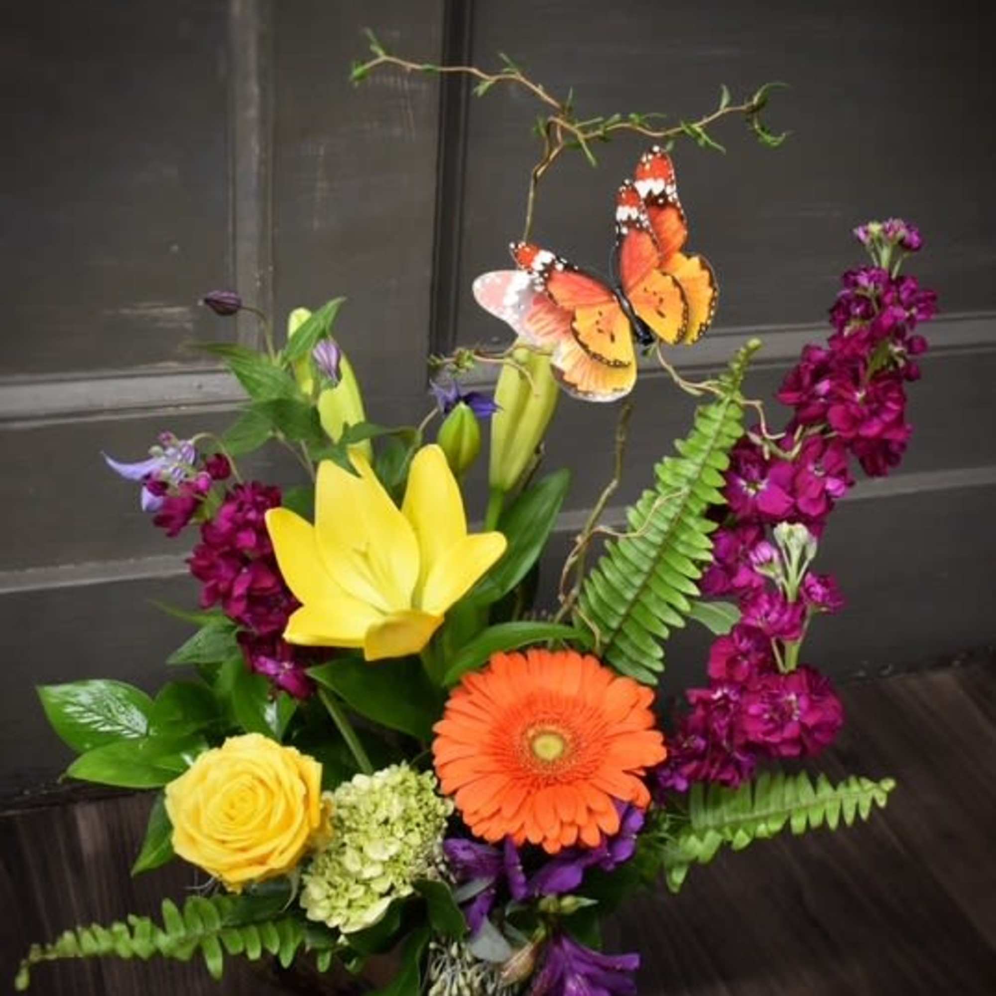 Colorful floral arrangement with a butterfly accent