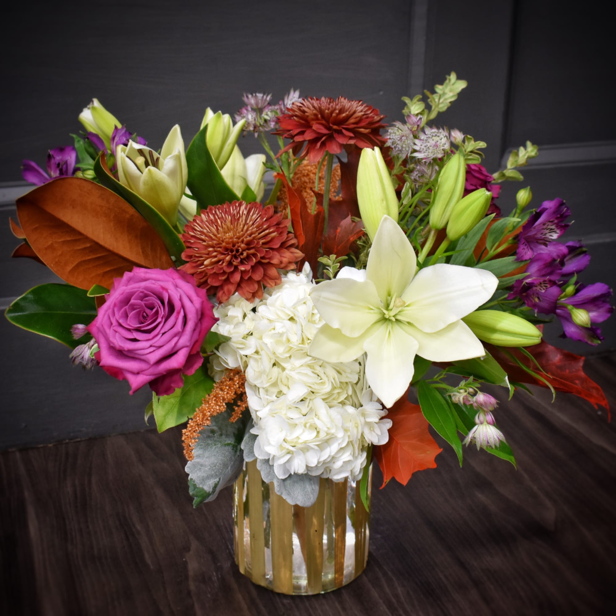 Mixed bouquet in a glass vase with lilies, roses, and hydrangea