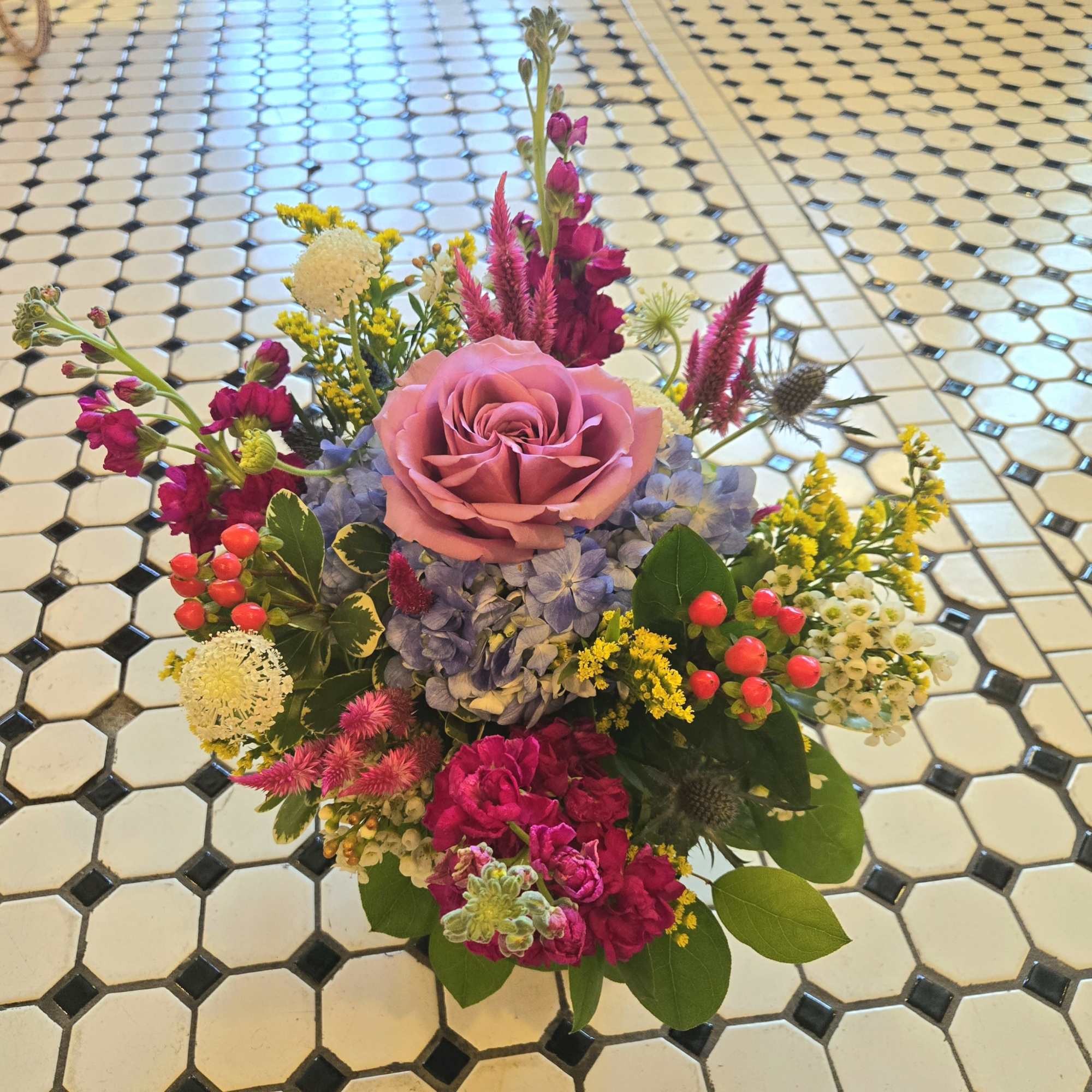 Mixed bouquet with a pink rose, blue hydrangea, and bright accent flowers, photo 2 of 3